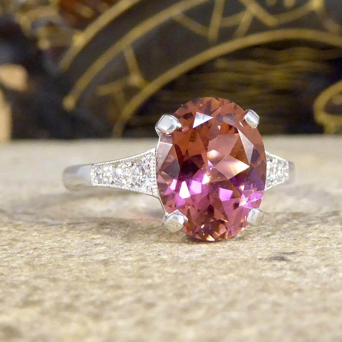 This stunning ring has been hand crafted and is new and never worn. It has been designed and carefully crafted to resemble an Art Deco style ring with bright and vibrant Pink Tourmaline gemstone in the centre weighing 2.38ct. On either side of the