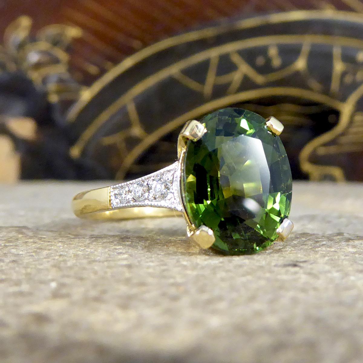 This stunning ring has been hand crafted and is new and never worn. It has been designed and carefully crafted to resemble an Art Deco style ring with a deep and mesmerising Green Tourmaline gemstone in the centre weighing 4.10ct. On either side of