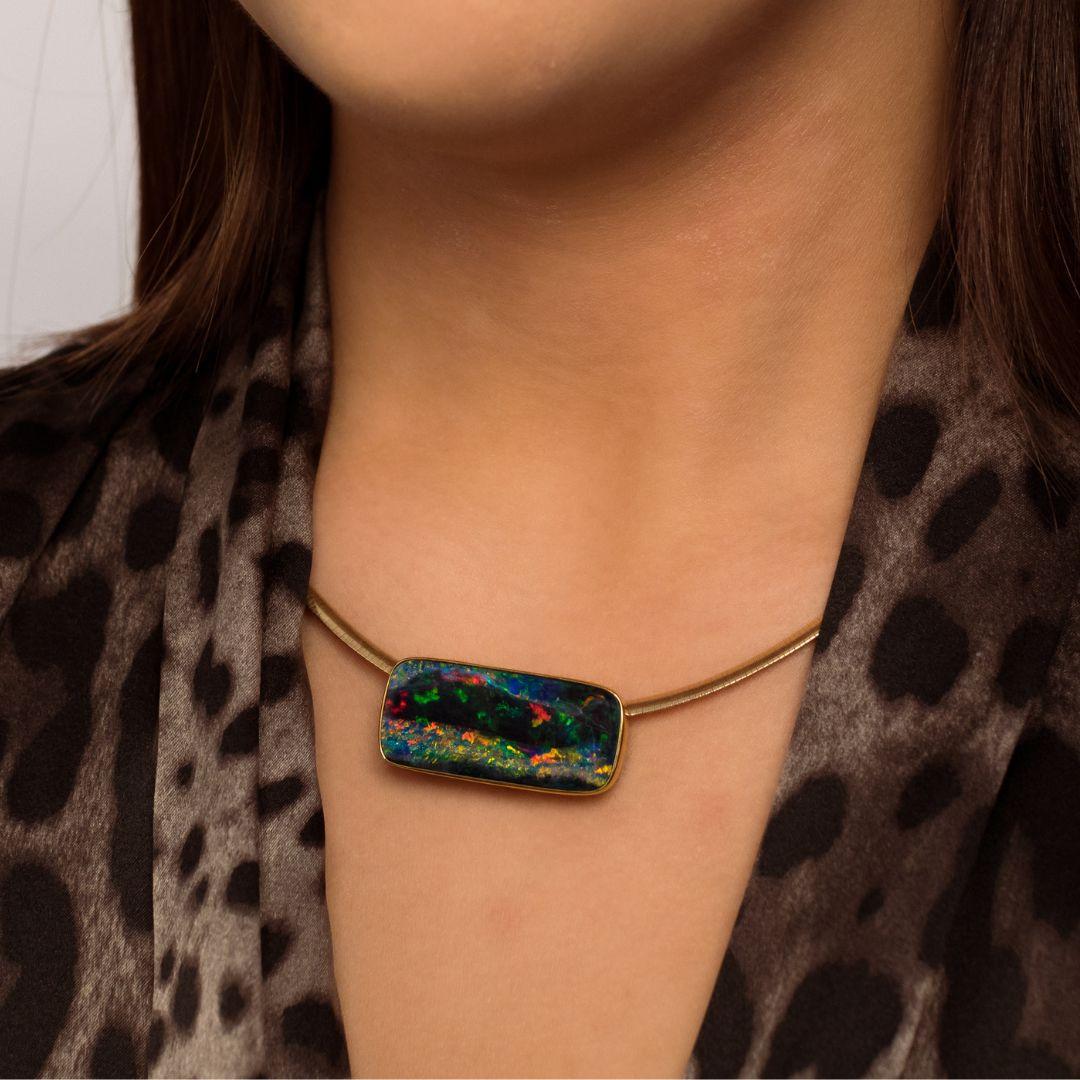 The striking beauty of nature manifests in the ‘Summertime’ opal pendant designed by Dr Renata Bernard. The impressive 22.62ct rainbow opal gemstone hails from the harsh Australian outback flirts impudently with the tromp l’oeil effect of the