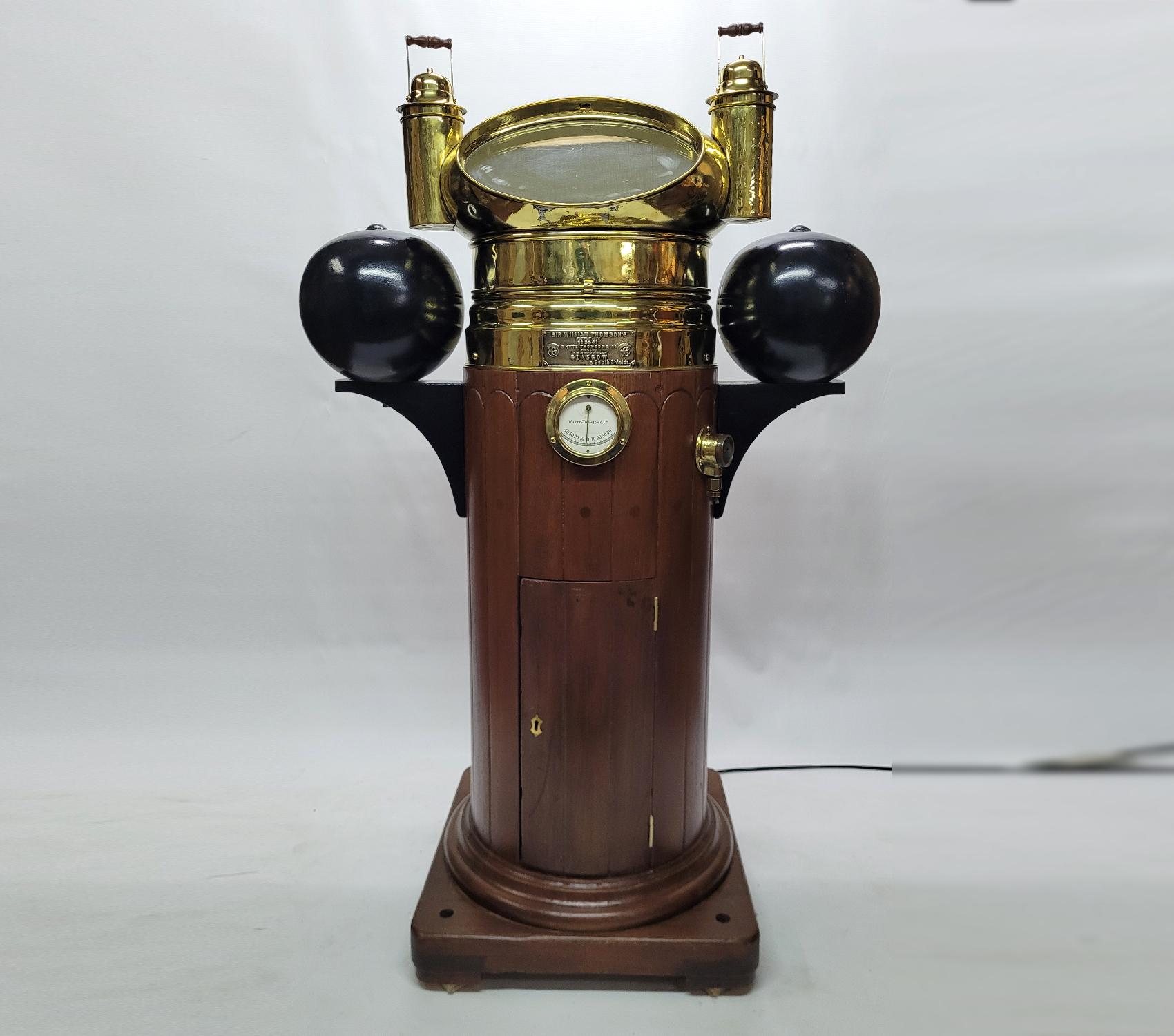 Absolutely rare and beautiful ships binnacle by Sir William Thomson of Glasgow. With a substantial varnished base. Polished and lacquered mushroom style hood and compass cowl. Very rare dry card compass on hanging gimbal, all polished to perfection.