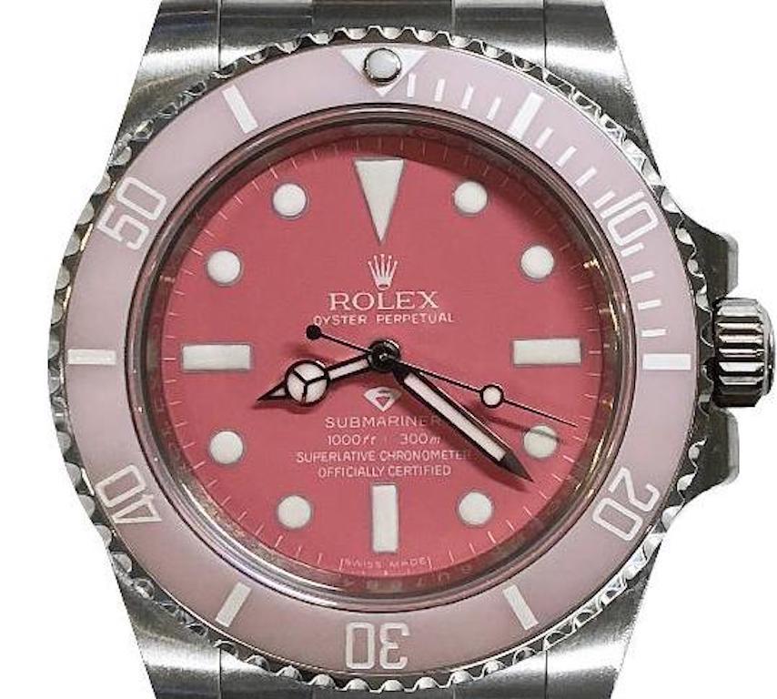 Manufacturer: Rolex

Model number: 114060

Model: Submariner 

Model Case: Oyster

Diameter: 40 mm

Material: Oyster steel

Bezel: Unidirectional rotatable 60-minute graduated, customized in light pink with a baby pink dial

Glass: Scratch-resistant