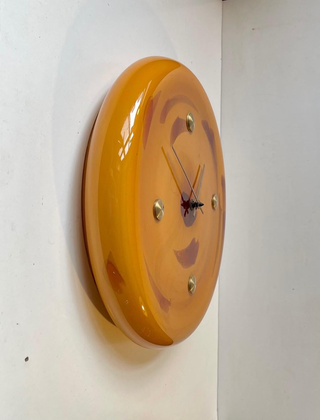 A very rare wall clock in caramel marble glass. Designed by female designer Sidse Werner in the mid 1970s. It is called President Wall Clock and this one is the largest in the series measuring 32 cm I diameter. It features over-sized brass dots at
