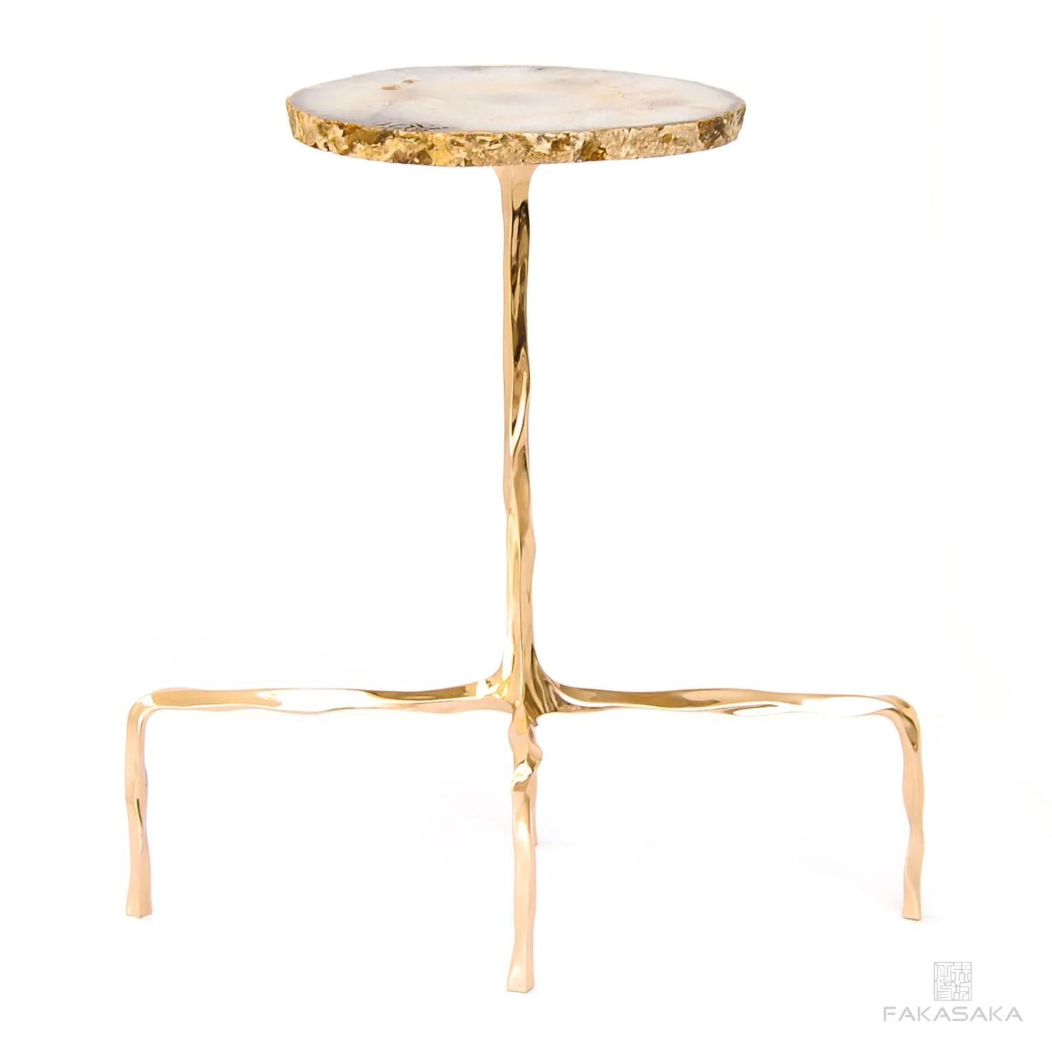 Presley drink table with Agate top by Fakasaka Design.
Dimensions: W 58 cm D 28 cm H 60 cm.
Materials: polished bronze base, Agate top.
Also available in different table top materials (Nero Marquina). 

 FAKASAKA is a design company focused on