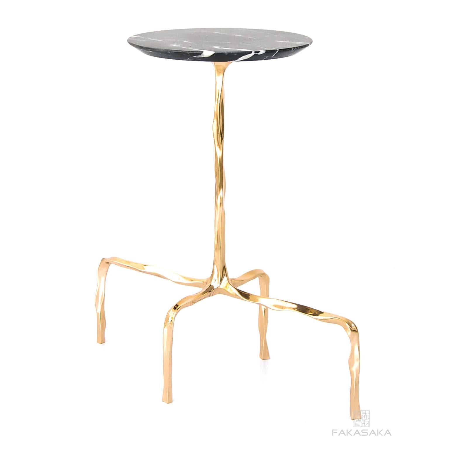 Presley drink table with Nero Marquina Marble top by Fakasaka Design.
Dimensions: W 58 cm D 28 cm H 60 cm.
Materials: polished bronze base, Nero Marquina marble top.
Also available in different table top materials (Agate).  

 FAKASAKA is a