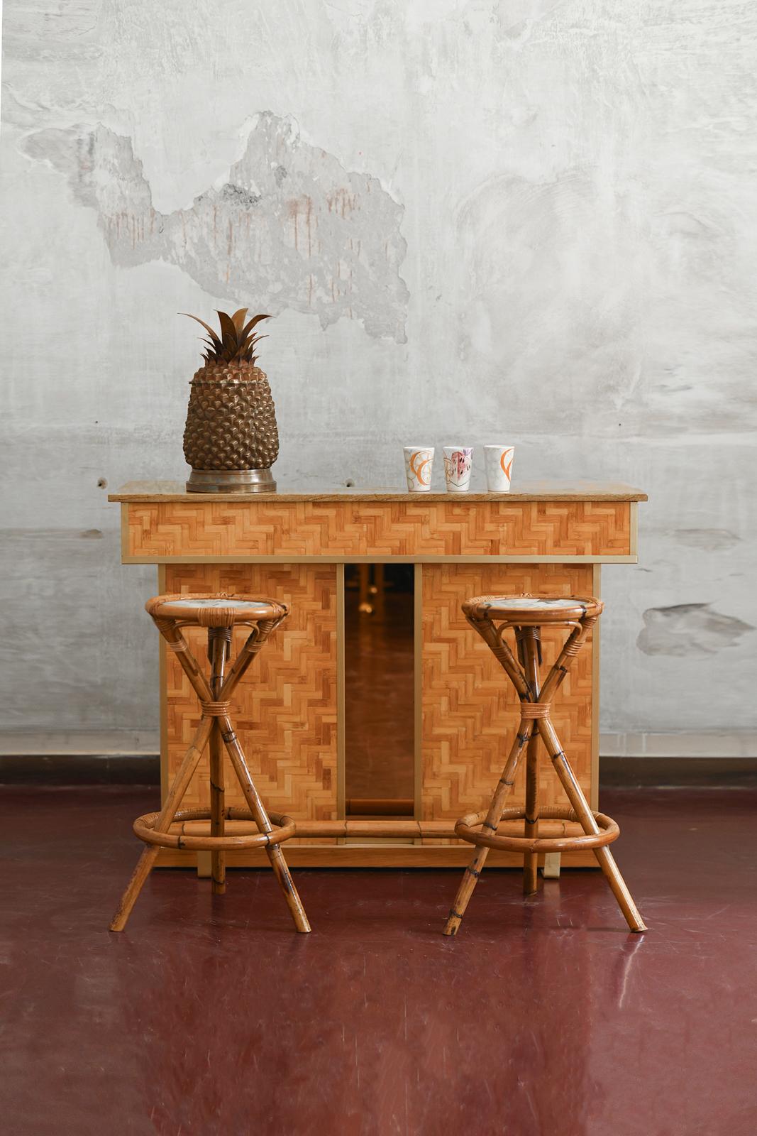 Pressed bamboo bar cabinet, marble top, and brass details, complete with bamboo stools featuring fabric seats, 1970s
Product Details
Back counter complete with drawers, shelves, and refrigerator.
The set includes the bar cabinet and the two stools.