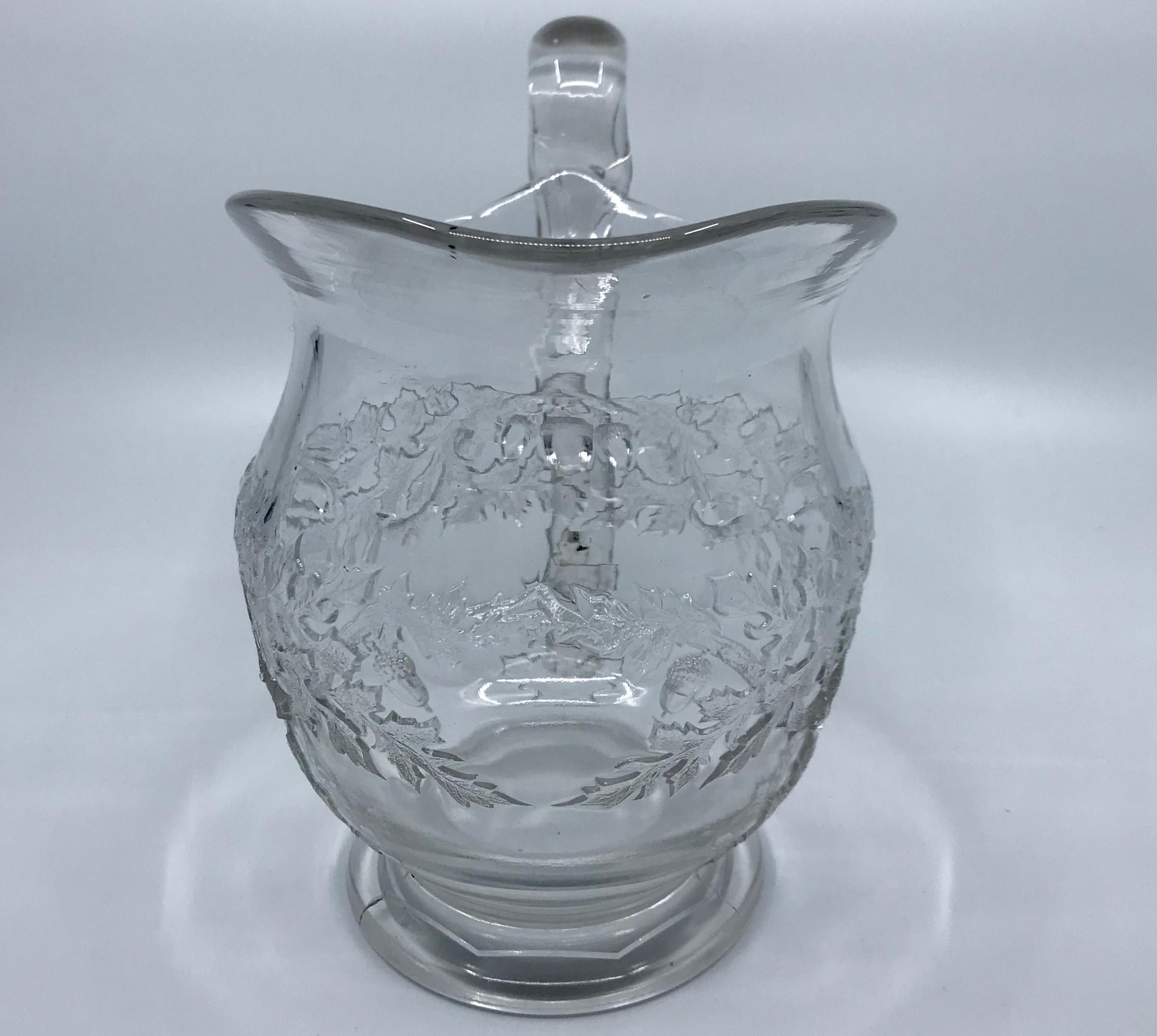 Pressed glass acorn and oak leaf pitcher. Hand blown and pressed glass pitcher with an oak leaf and acorn motif, United States, 1850s.
Dimensions: 7.75