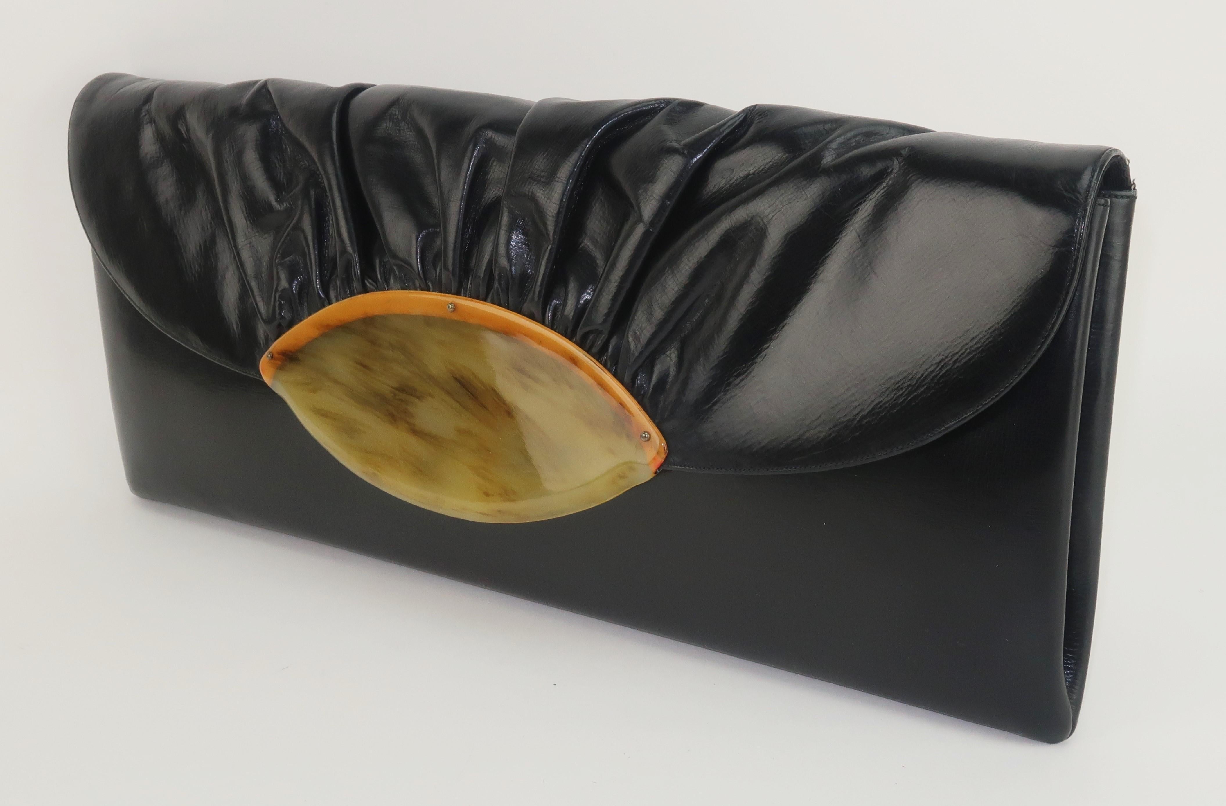 Long, strong and statement making 1940's black leather clutch handbag by American company, Prestige.  The glossy black leather is perfectly enhanced with a ruched front flap and amber lucite embellishment.  The flap opens to reveal an envelope style