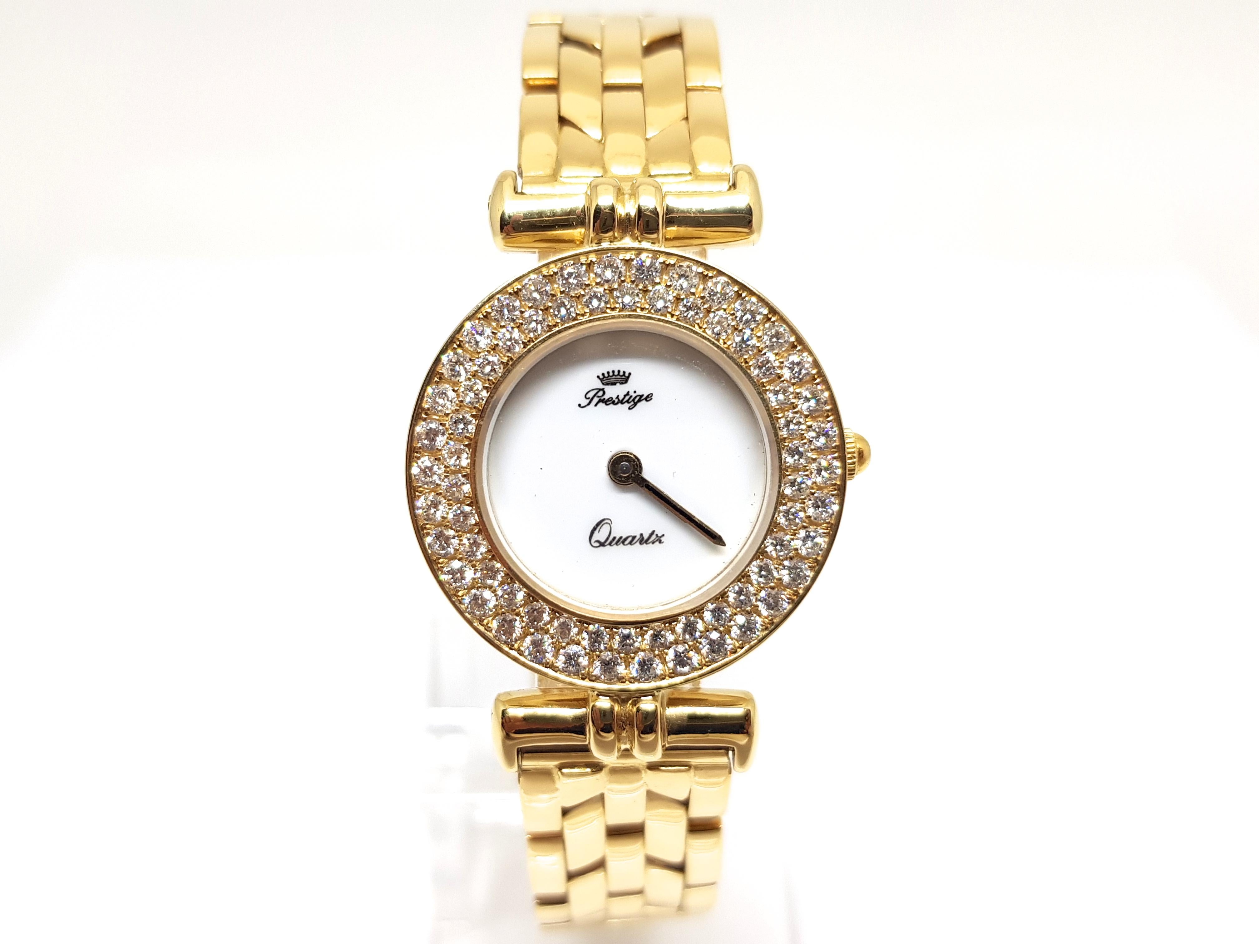 Brand: Prestige
Gold: 18 K Yellow gold 
White dial 
Quartz Movement 
Weight: 62,6 grams. 
Diamonds: 1,70ct. 
Diameter with crown: 25mm 
Age: ca. 2000-2010 
Length: 17,0cm. 
Gold Clasp 
All our jewellery comes with a certificate and a 5 year