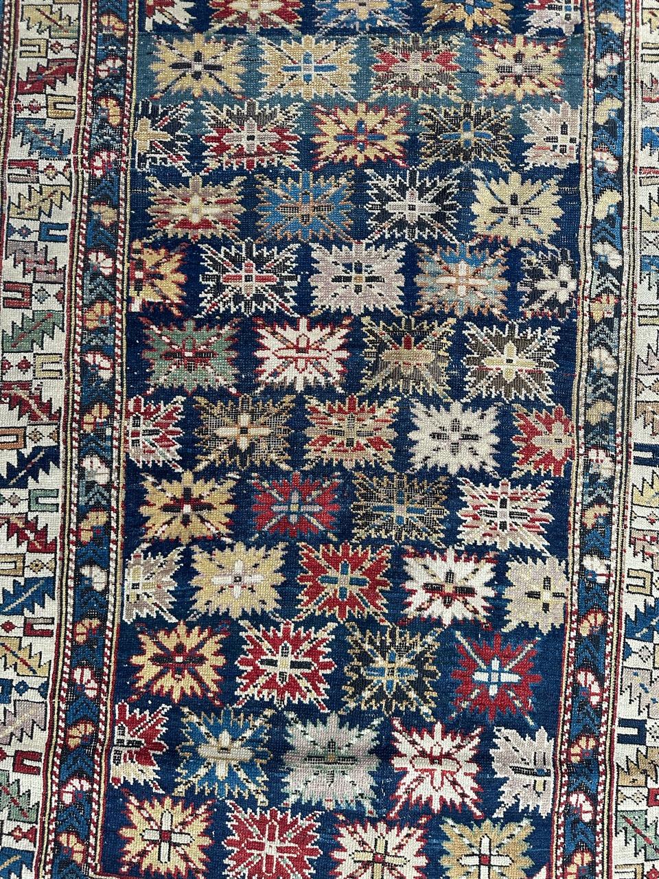 Beautiful antique Caucasian Shirwan carpet from the late 19th century, entirely hand-knotted in wool on a wool foundation, featuring natural and vegetable dyes. The carpet's central motif showcases stylized star-like patterns filling the field with
