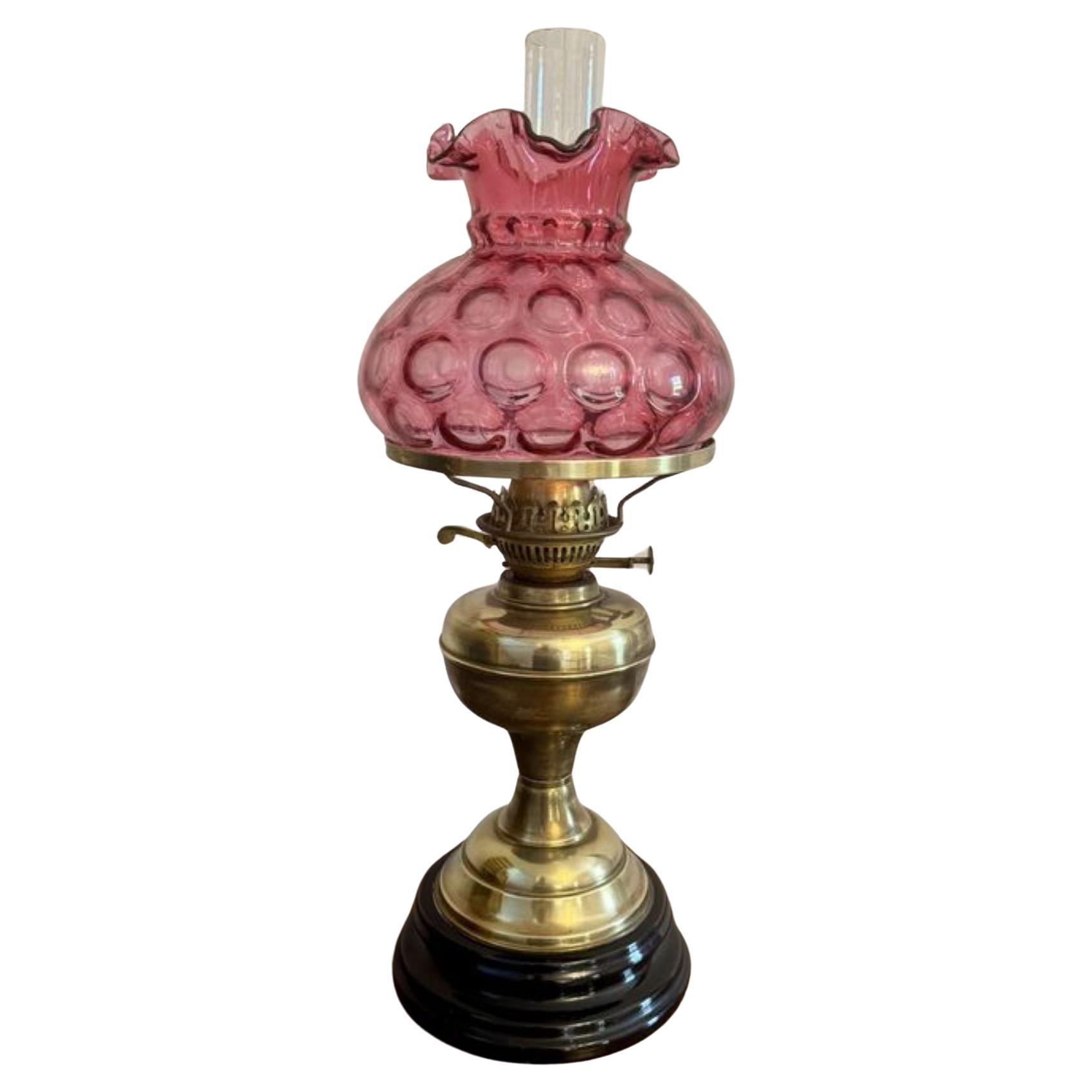 Pretty antique Edwardian brass oil lamp with cranberry glass shade