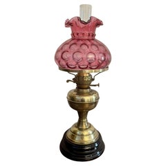 Pretty antique Edwardian brass oil lamp with cranberry glass shade