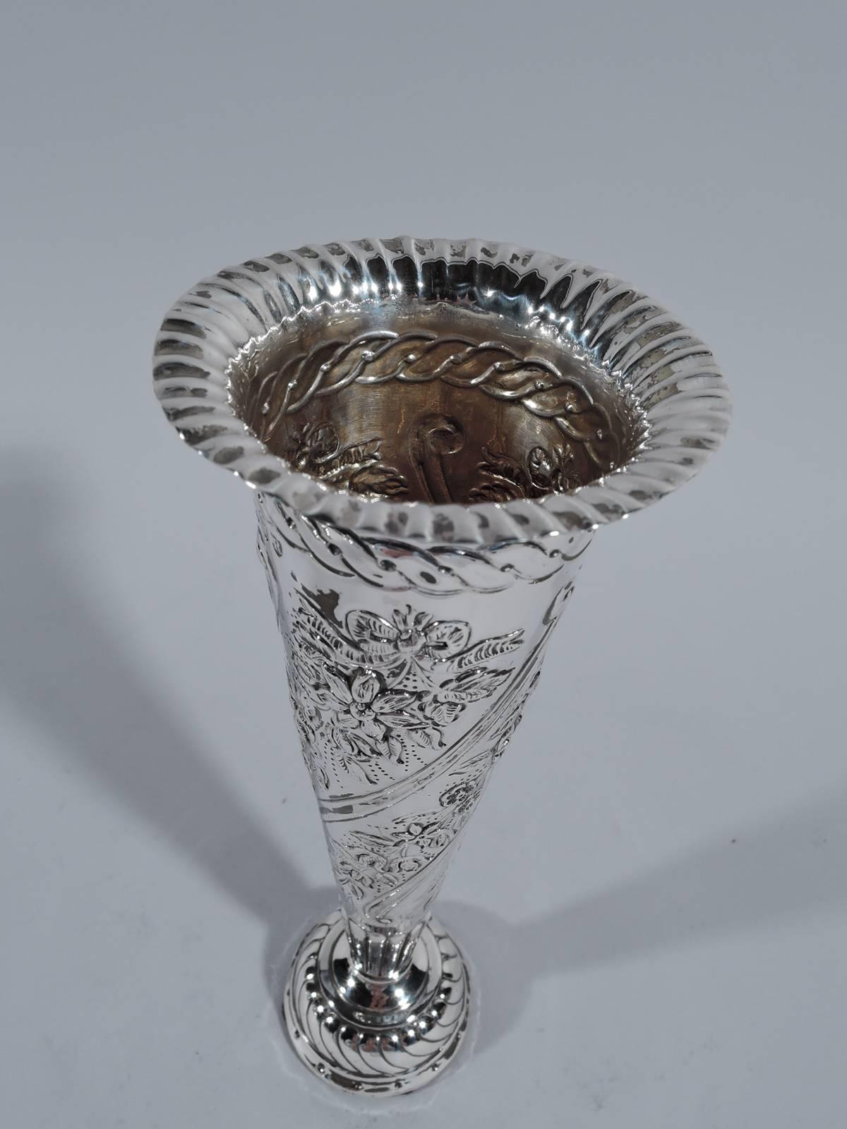 Victorian sterling silver vase. Made by William Comyns in London in 1892. Conical with crimped gadrooned rim and gadrooned and domed foot. Twisted flutes and garlands and guilloche border. A pretty piece in the tradition of putting the flowers on