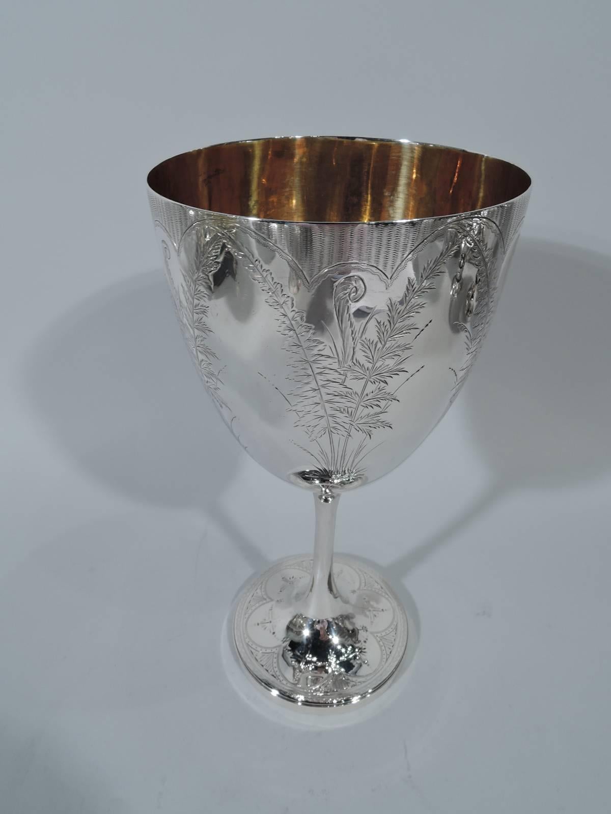 Victorian sterling silver goblet. Made by Roberts & Belk, Ltd in Sheffield in 1872. Tapering bowl on tall cylindrical stem terminating in raised foot. Engraved frond arcade and engine-turned rim ornament. Gilt interior. Fresh and pretty with plenty