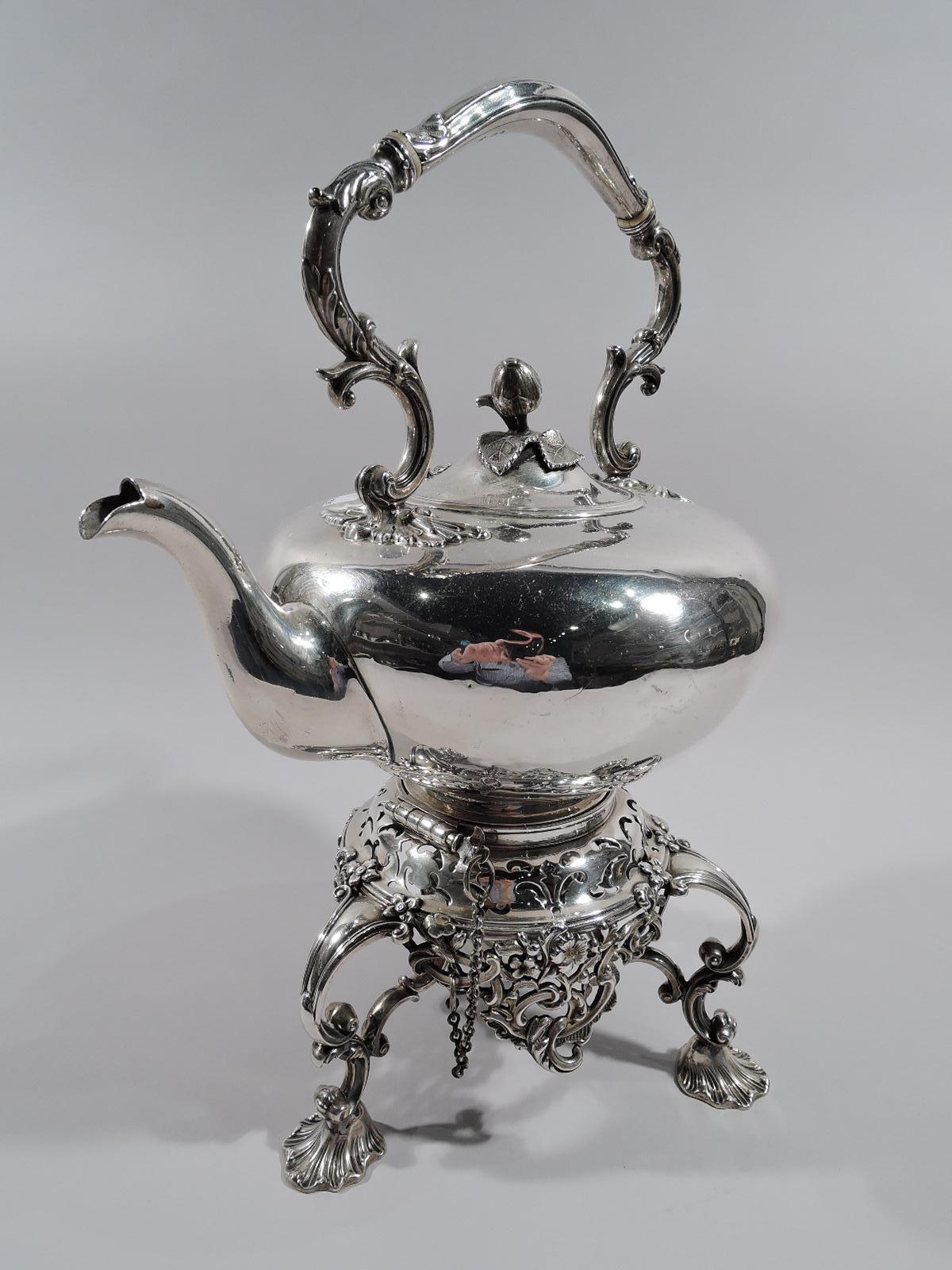 Victorian sterling silver kettle on stand. Made by James & Nathaniel Creswick in Sheffield in 1855. Kettle: Ovoid with s-scroll and reeded foot; cover hinged and domed with scroll and leaf mounts and cast bud finial; leaf-capped and scrolled