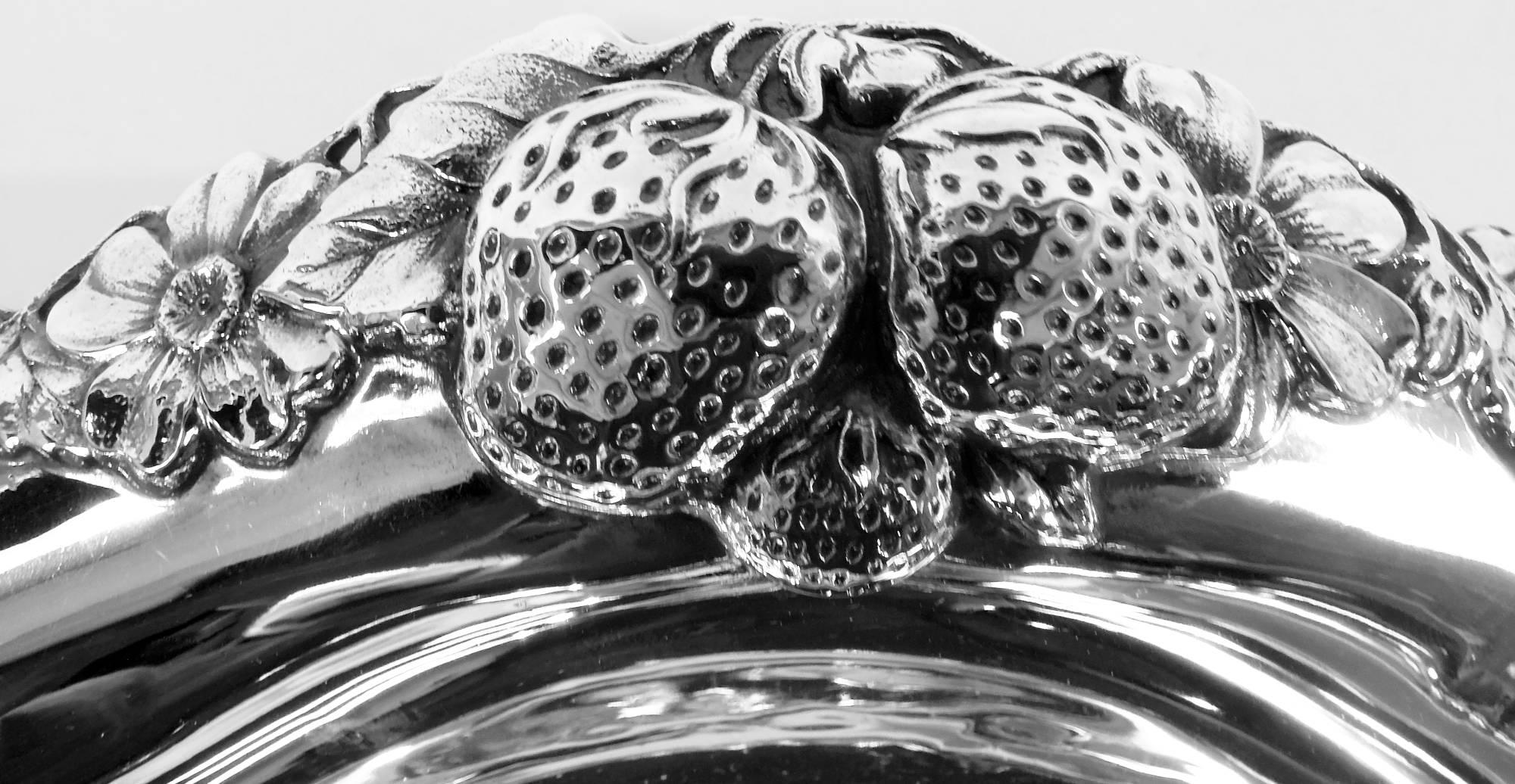 Edwardian sterling silver bowl. Made by Gorham in Providence in 1912. Plain well and pierced and wavy rim. Strawberries, blackberries, and cherries as well as blossoms applied to rim. A pretty design that captures the lush ripeness of the fruit.