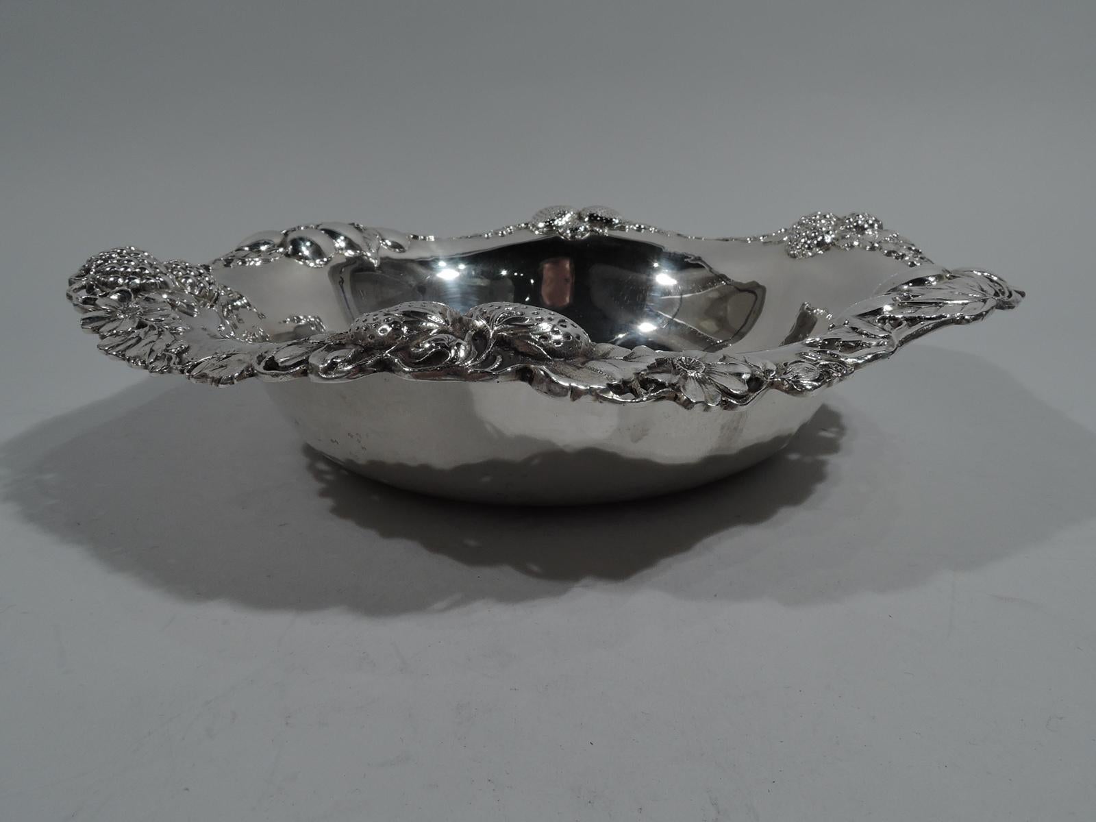 Sterling silver bowl. Made by Gorham in Providence in 1912. Plain well and pierced and wavy rim. Strawberries, blackberries, and cherries as well as blossoms applied to rim. A pretty design that captures the lush ripeness of the fruit. Fully marked