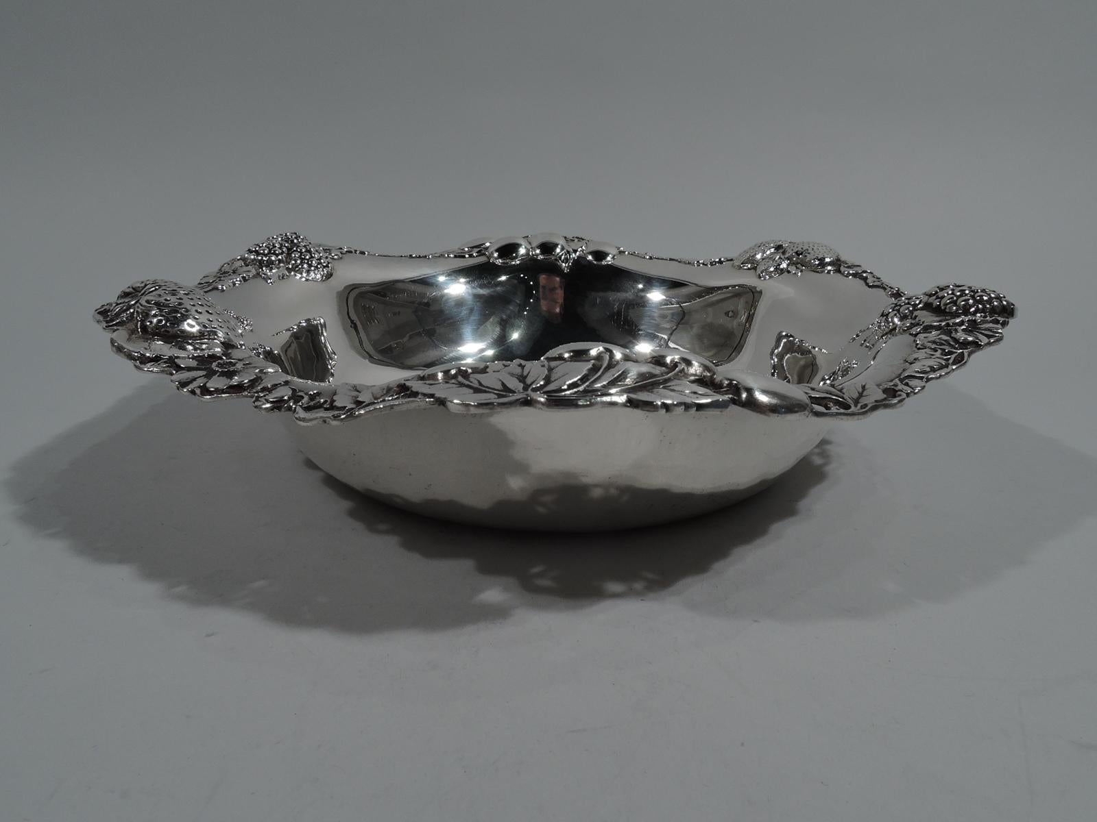 Sterling silver bowl. Made by Gorham in Providence in 1904. Plain well and pierced and wavy rim. Strawberries, blackberries, and cherries as well as blossoms applied to rim. A pretty design that captures the lush ripeness of the fruit. Fully marked