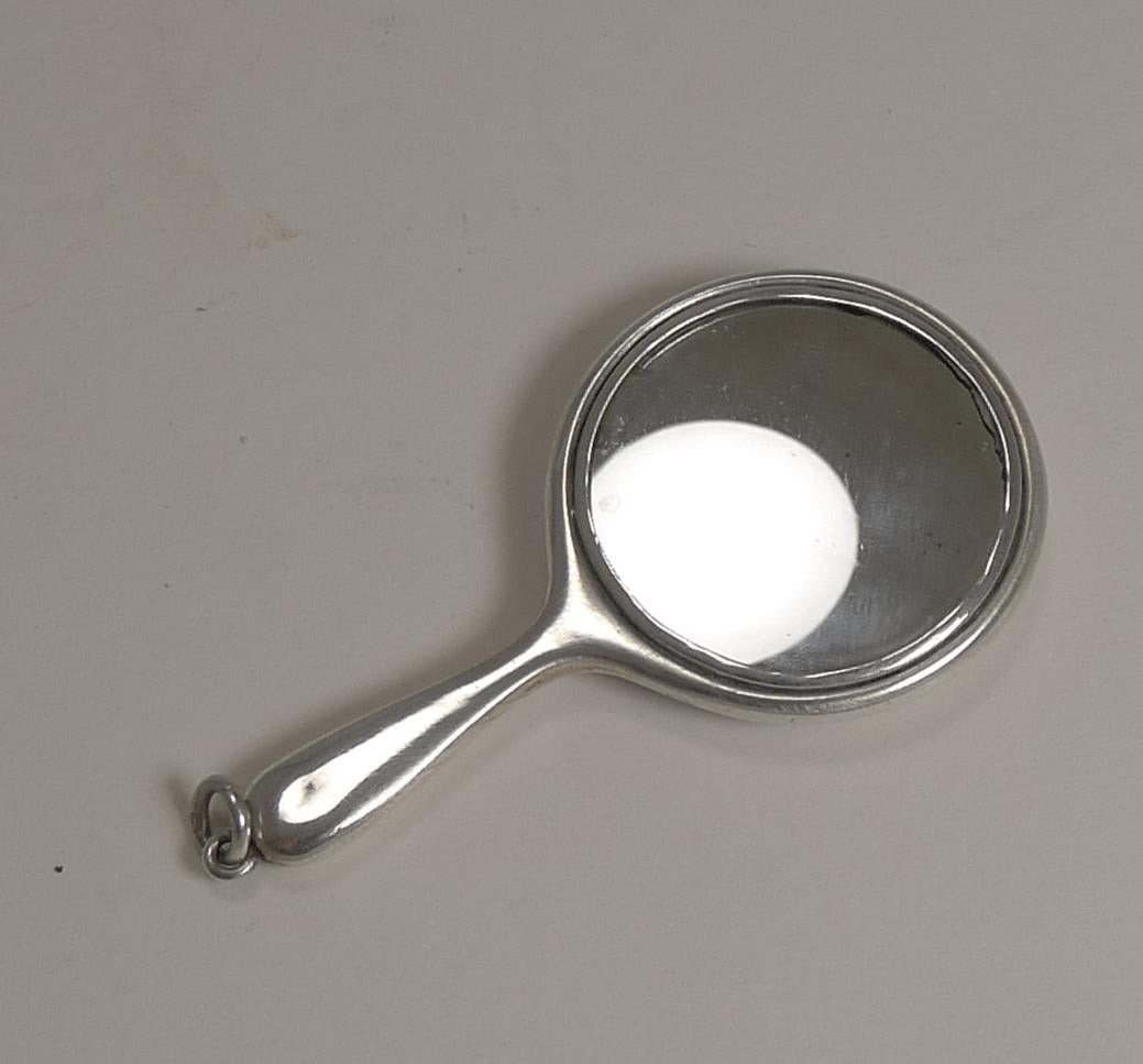 A stunning little mirror, perfect for the handbag or purse or even on a chain around the neck; made from sterling silver in the form of a hand mirror measuring just 2 1/2