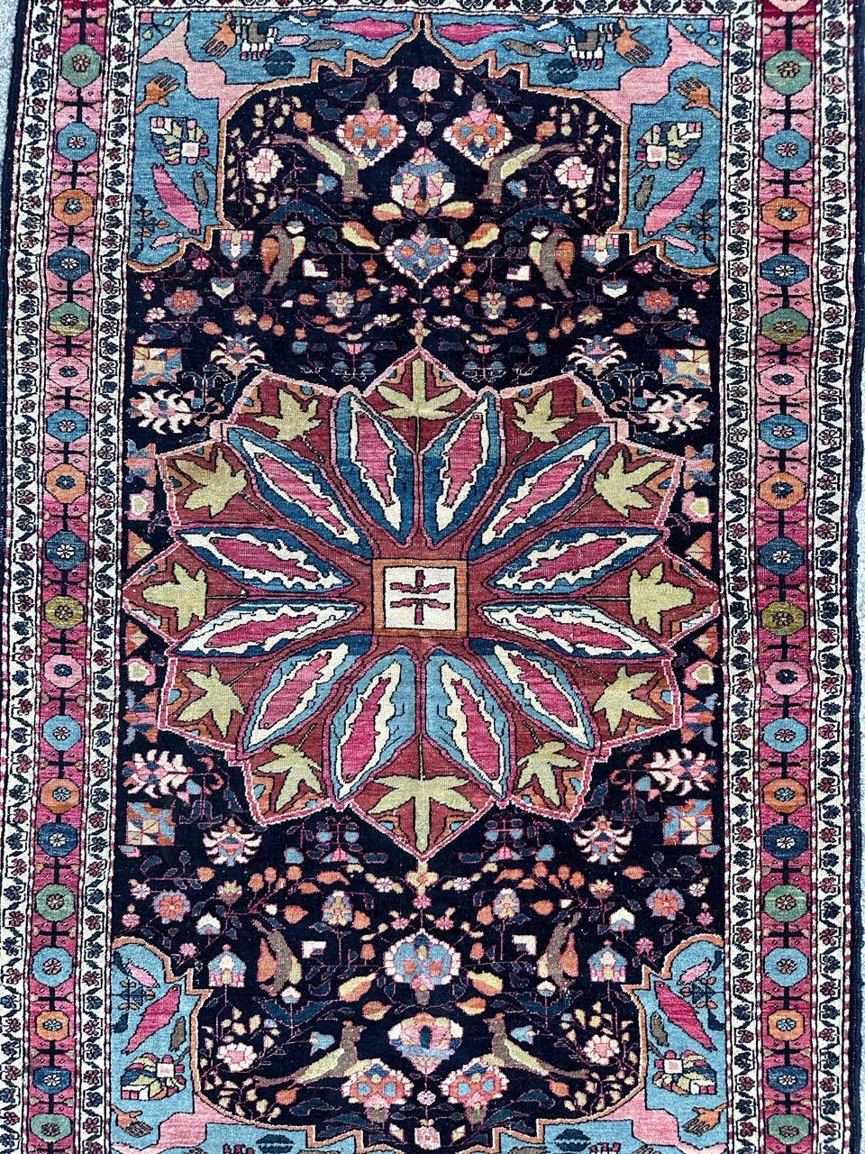 Discover a stunning early 20th-century rug that exudes elegance! This exquisite piece features a captivating floral and central medallion design, all meticulously hand-knotted with wool velvet on a cotton foundation. The deep blue background sets