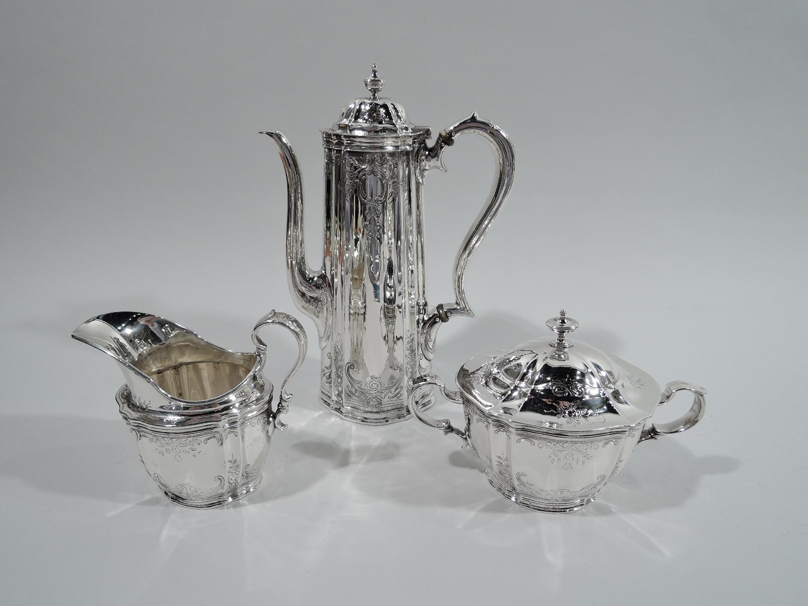Victorian sterling silver 3-piece coffee set. Made by Tiffany & Co. in New York. This set comprises coffeepot, creamer, and sugar. Ovoid and fluted bodies. Capped double-scroll handles. Domed covers with vasiform finials. Engraved ornament: Leafing