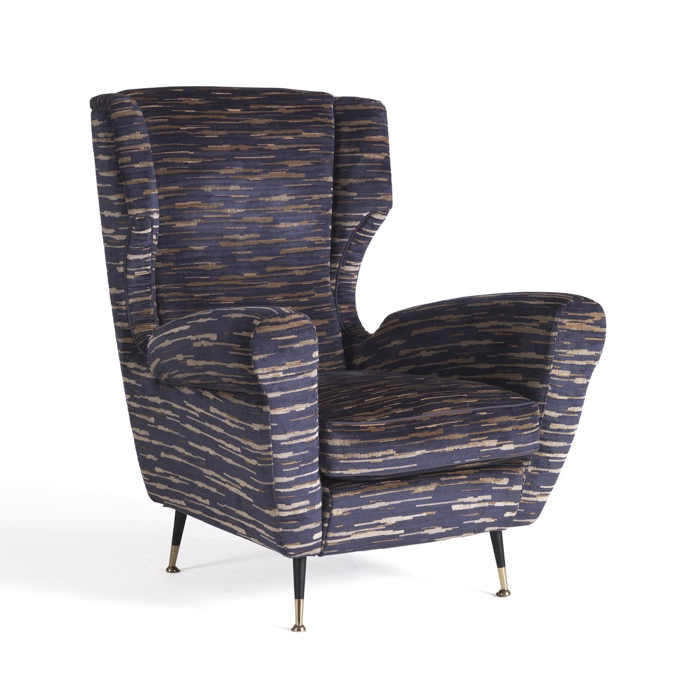 Exuding impeccable comfort in its welcoming and embracing silhouette, this armchair is a versatile piece of functional decor that will suit both residential and commercial interiors. Resting on black metal feet with a polished golden ferrules, the