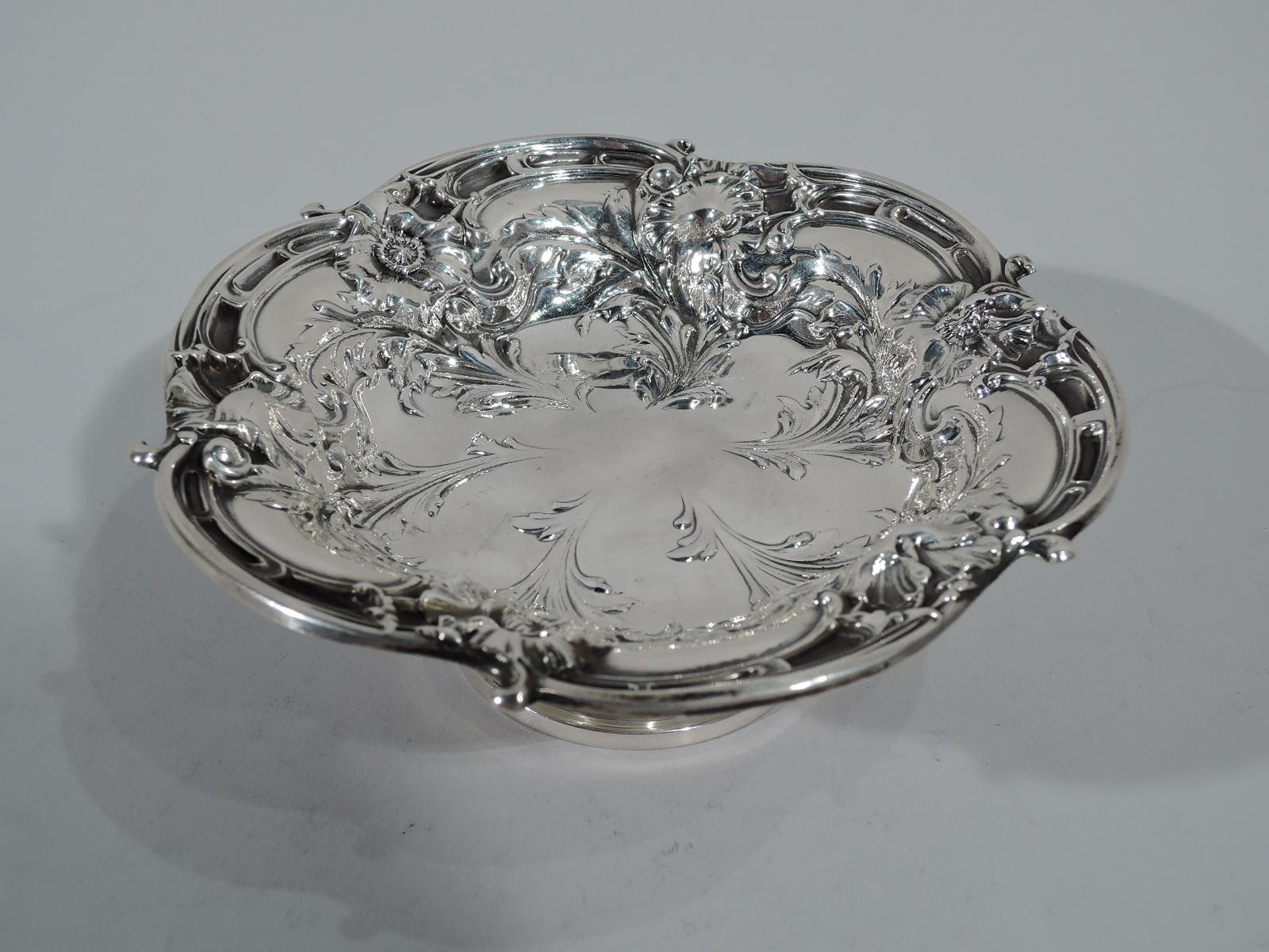 Pretty Art Nouveau sterling silver footed bowl. Made by Reed & Barton in Taunton, Mass. in 1949. Shallow and lobed bowl on domed foot. Bowl interior has chased wildflowers and foliage. Hallmark includes date symbol and no. X279. Weight: 4.6 troy