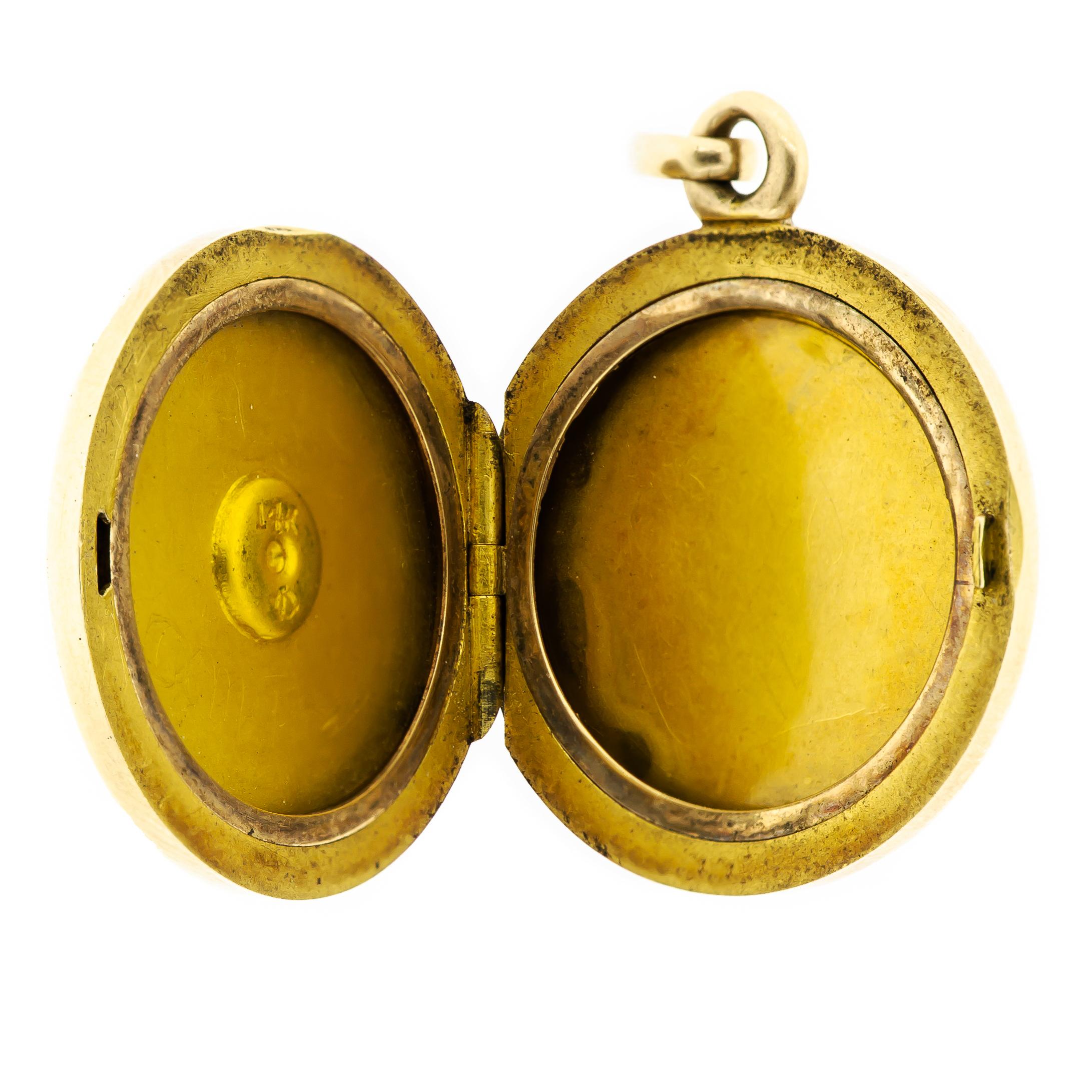 Lovely circa 1900 round antique locket handcrafted in 14kt yellow gold. Interesting swirl design is depicted on both sides of the locket. Both of the inside frames are intact. This is a sturdy little piece that is extremely striking for its size.