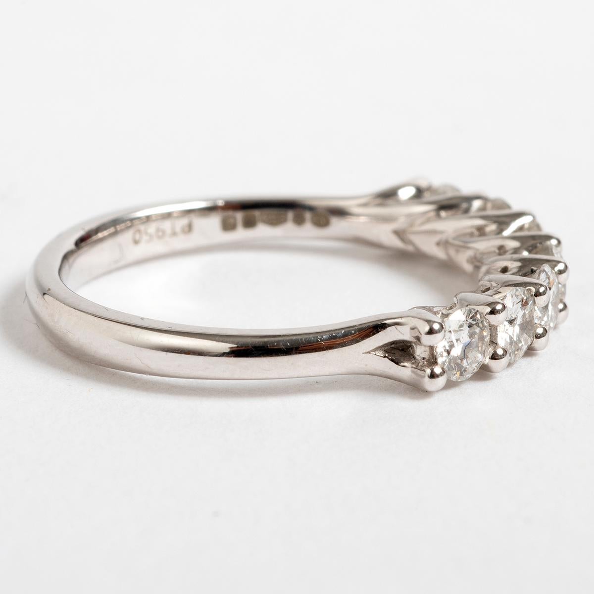 This pretty diamond 1/2 eternity ring is set with 7 stone claw in platinum. Total approx 0.70carat. This ring is a UK size M and US size 6.5.