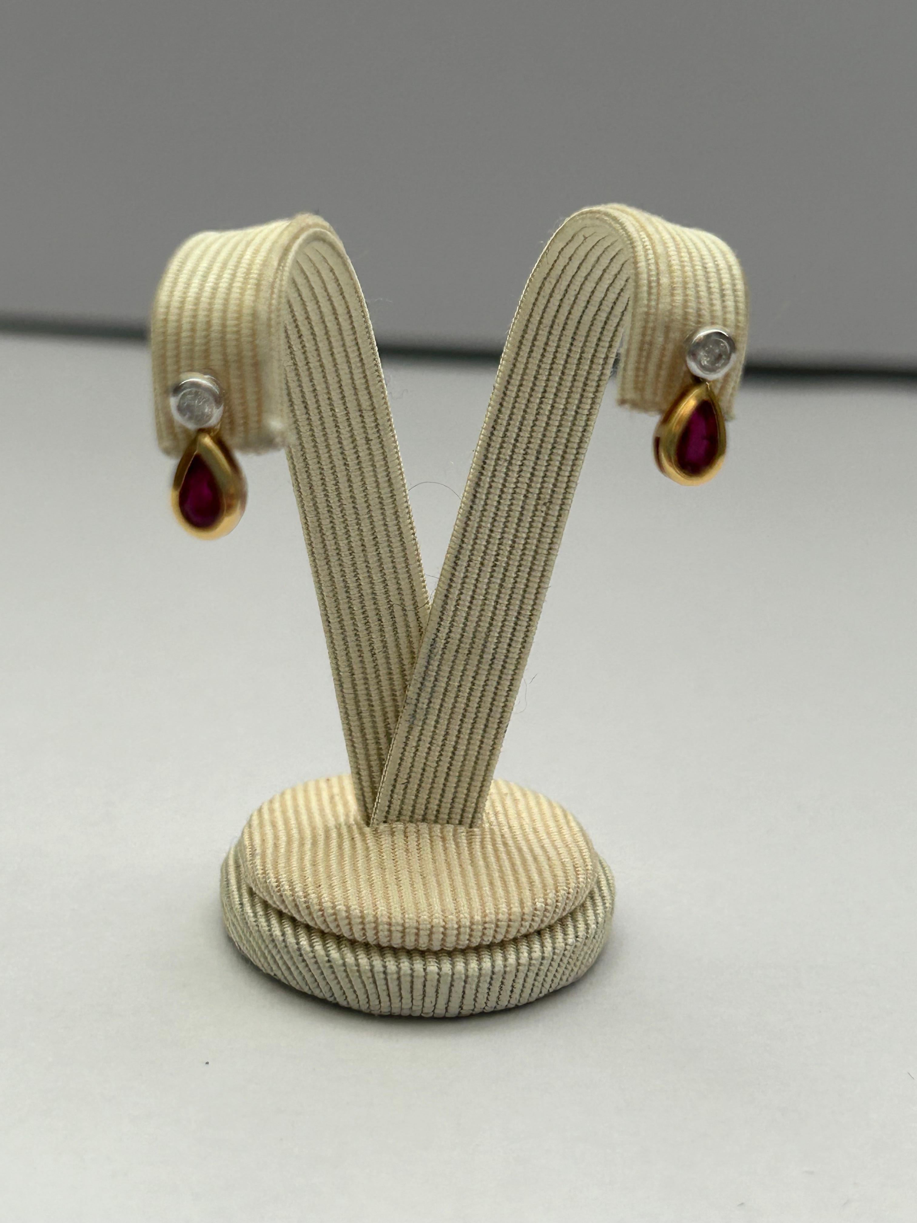 These pretty diamond and ruby drop earrings set in yellow gold measure 10mm, diamonds est 0.08ct and ruby est .49ct.  We do have a matching necklace in our store too.