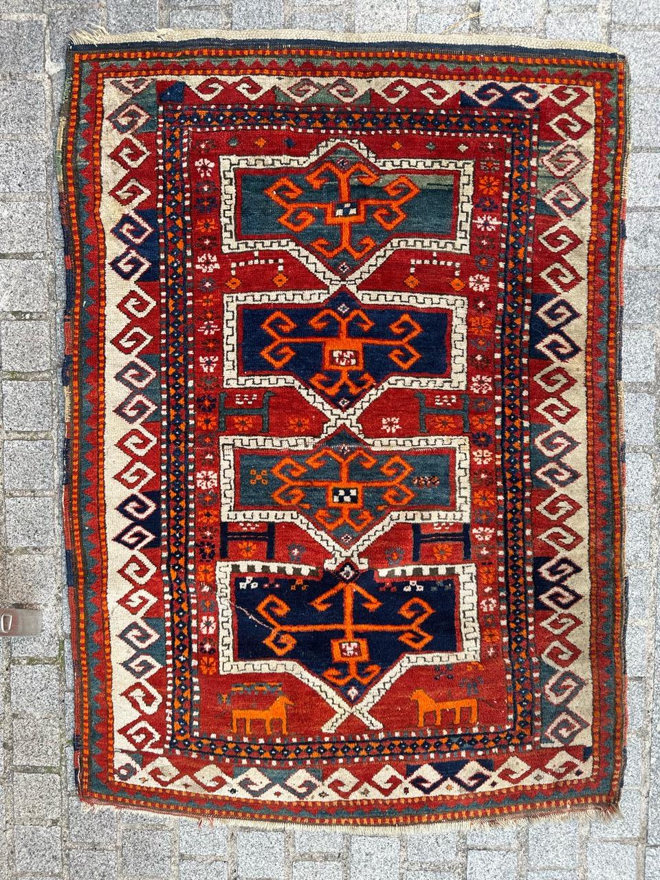 Authentic Early 20th Century Kazak Caucasian Rug entirely hand knotted with wool velvet on wool foundation 
Step into a world of vibrant history with our exquisite early 20th century Kazak rug. Immerse yourself in the rich hues of orange, red, blue,