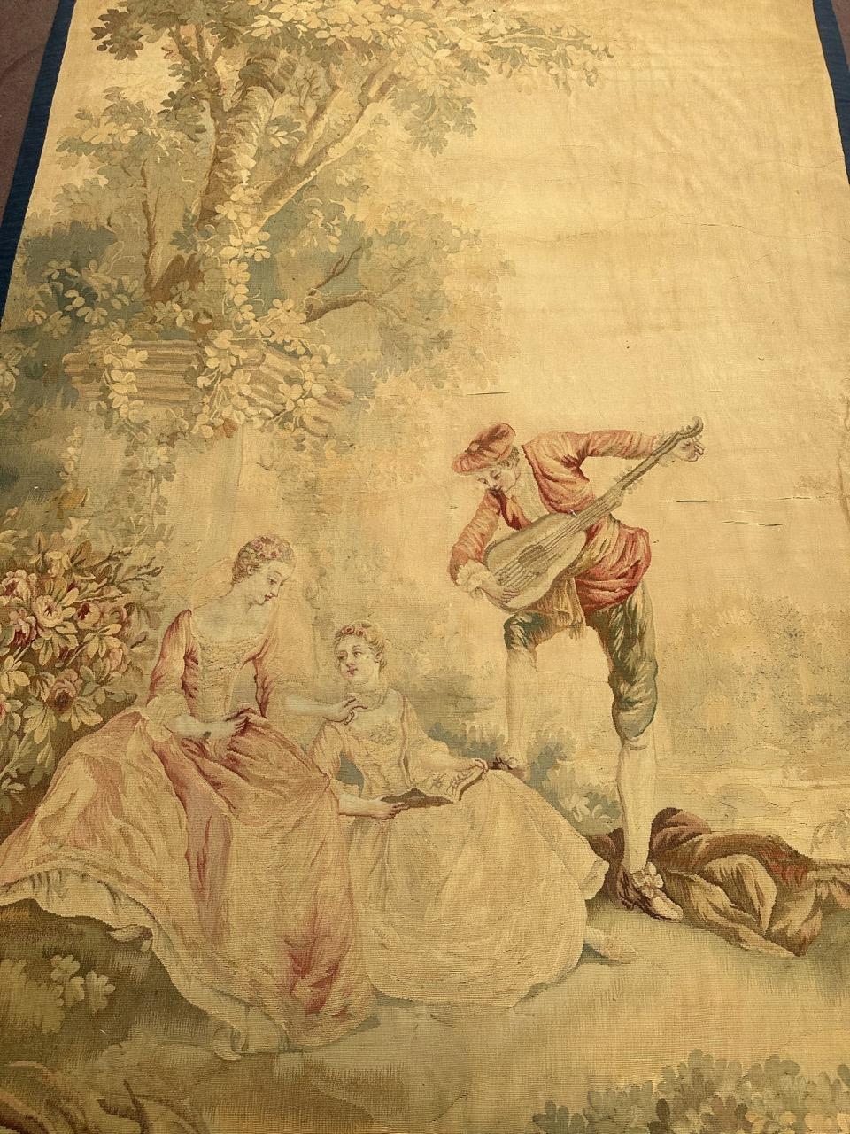 Very beautiful late 19th century French Aubusson tapestry  with a nice design in the garden, two women sitting and talking while a man plays music, with nice light colours with yellow, green, pink and red, entirely and very finely hand woven by silk