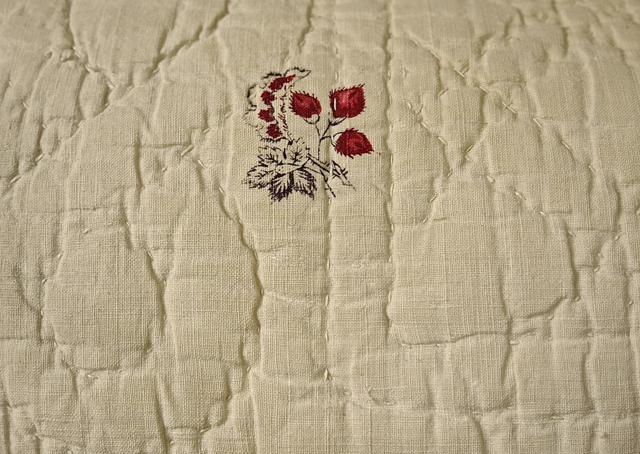 18th century French soft cotton cushion block printed with delicately drawn flower motifs. Soft raspberry pink and pale blue flowers with pale mauve leaves and stems make a fresh and charming textile. Simply quilted in a pattern of circles