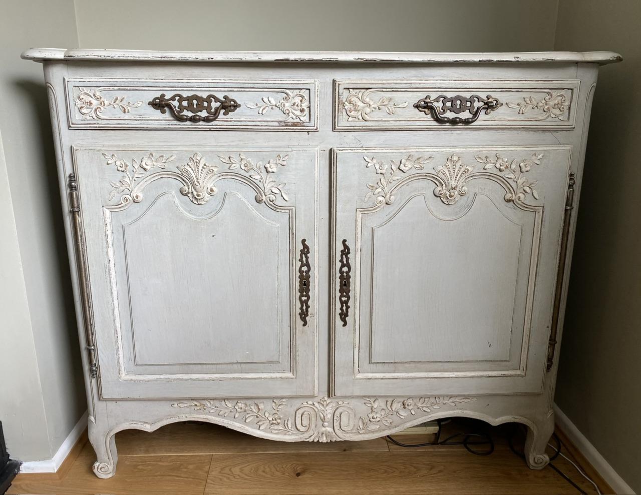A very pretty French original painted Cupboard or Cabinet. Having 2 doors opening to reveal a single shelf inside and 2 drawers over, all fittwd with original hardware. Lovely carved decoration to the front and finished in its original paint finish