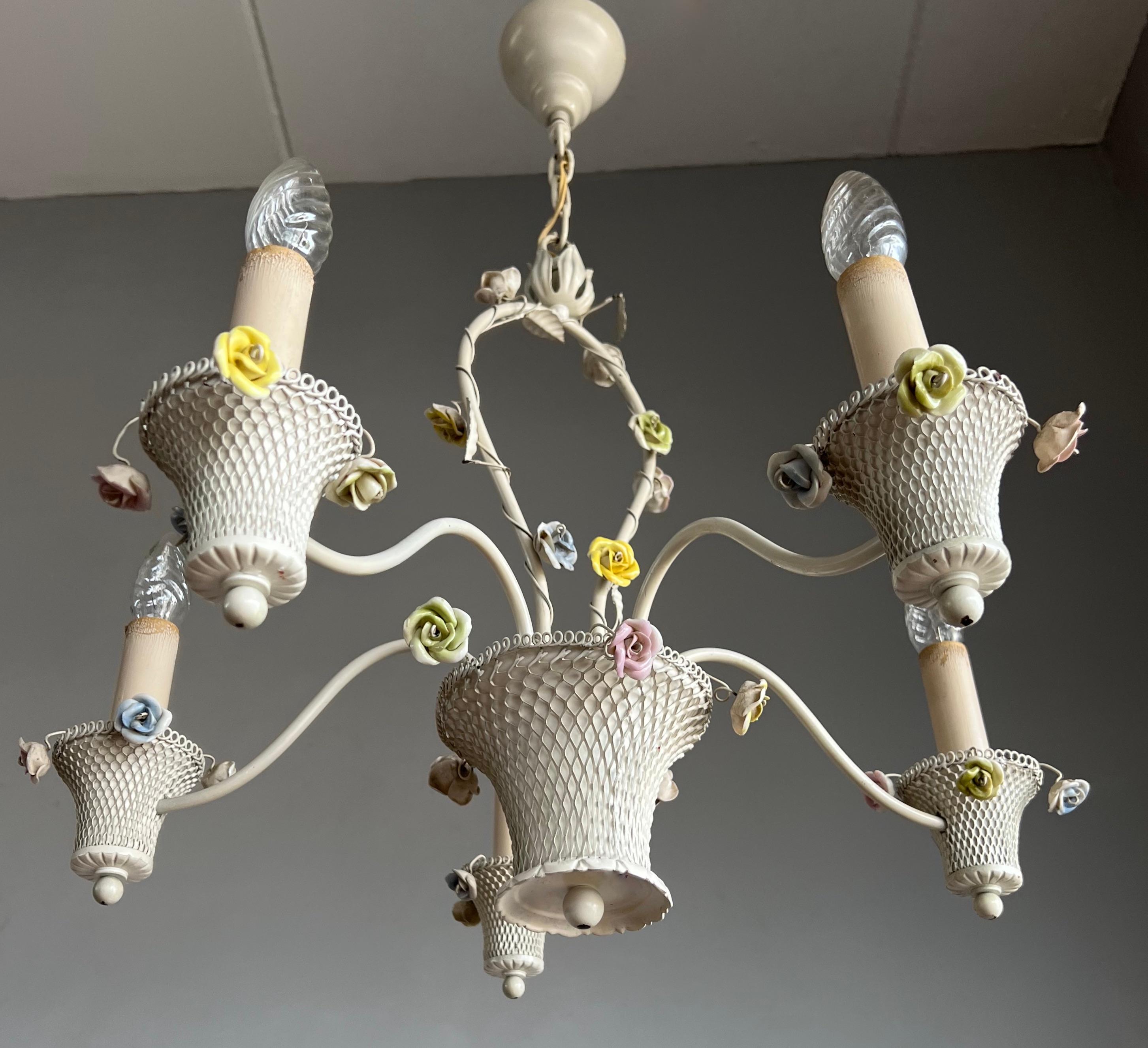 Original design, all hand-crafted in Italy, pendant light with white metal baskets and porcelain flowers.

This well designed and beautifully executed chandelier is a joy to look at, also, because it is in mint condition. If you like having flowers