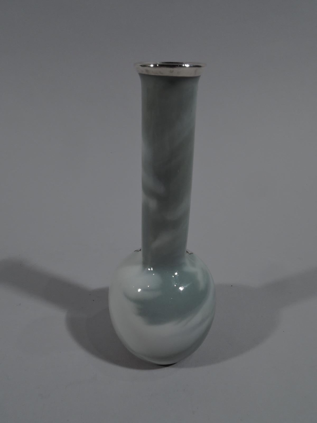 Pretty porcelain bud vase with engraved silver overlay, circa 1920. Tall cylindrical neck and globular body in marbleized green and white. On front is vertical floral overlay with entwined stem flowers of which one encircled by leaves.
