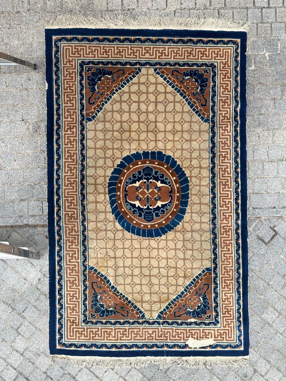 Introducing a stunning mid-century Chinese rug featuring exquisite Chinese Art Deco-style design and captivating colors. This entirely hand-knotted masterpiece showcases a central navy blue medallion adorned with stylized Chinese animal motifs in