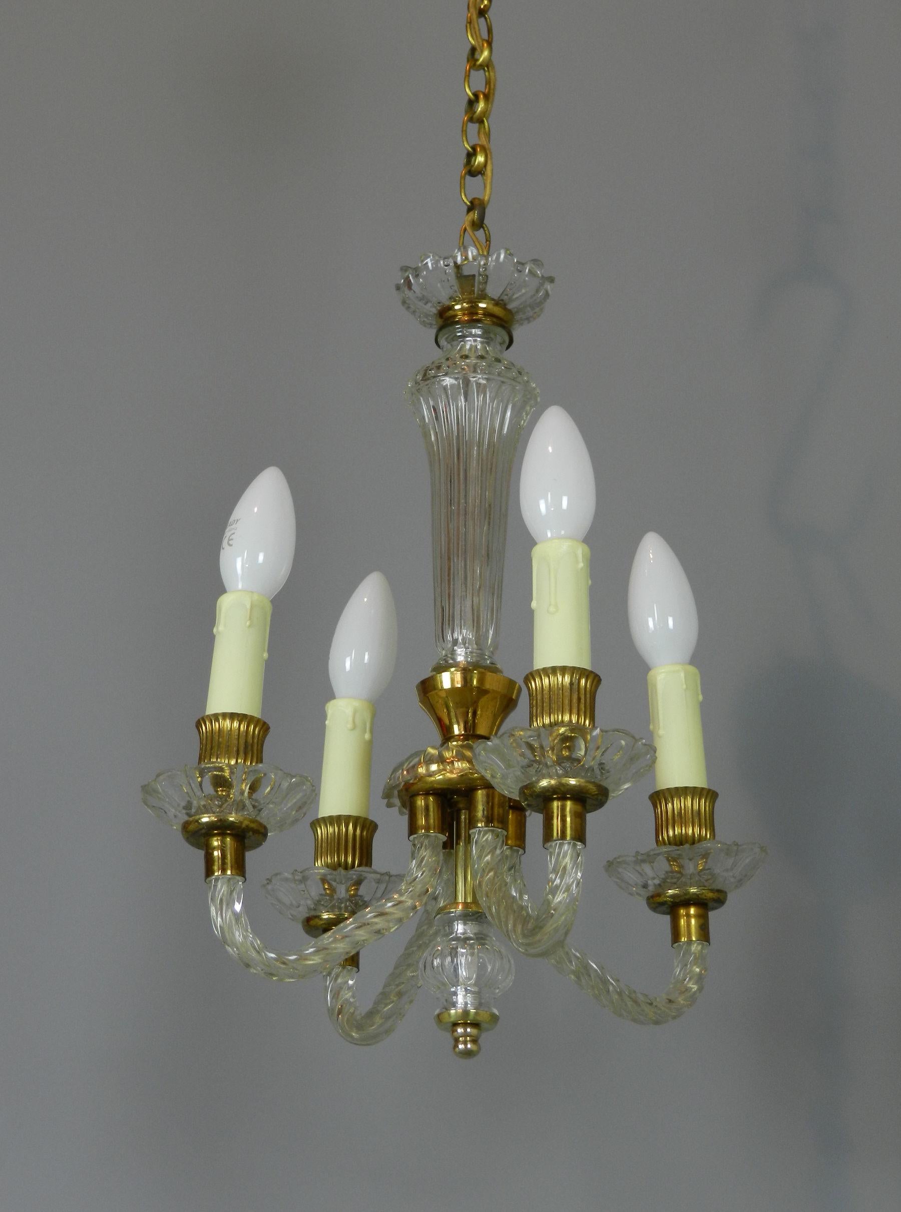 A very pretty four light chandelier in Murano glass with gold metal work.

The central column leads down to four twisted glass arms holding candle light bulbs.

Tested and in full working order. As with all lighting we advise that it is checked