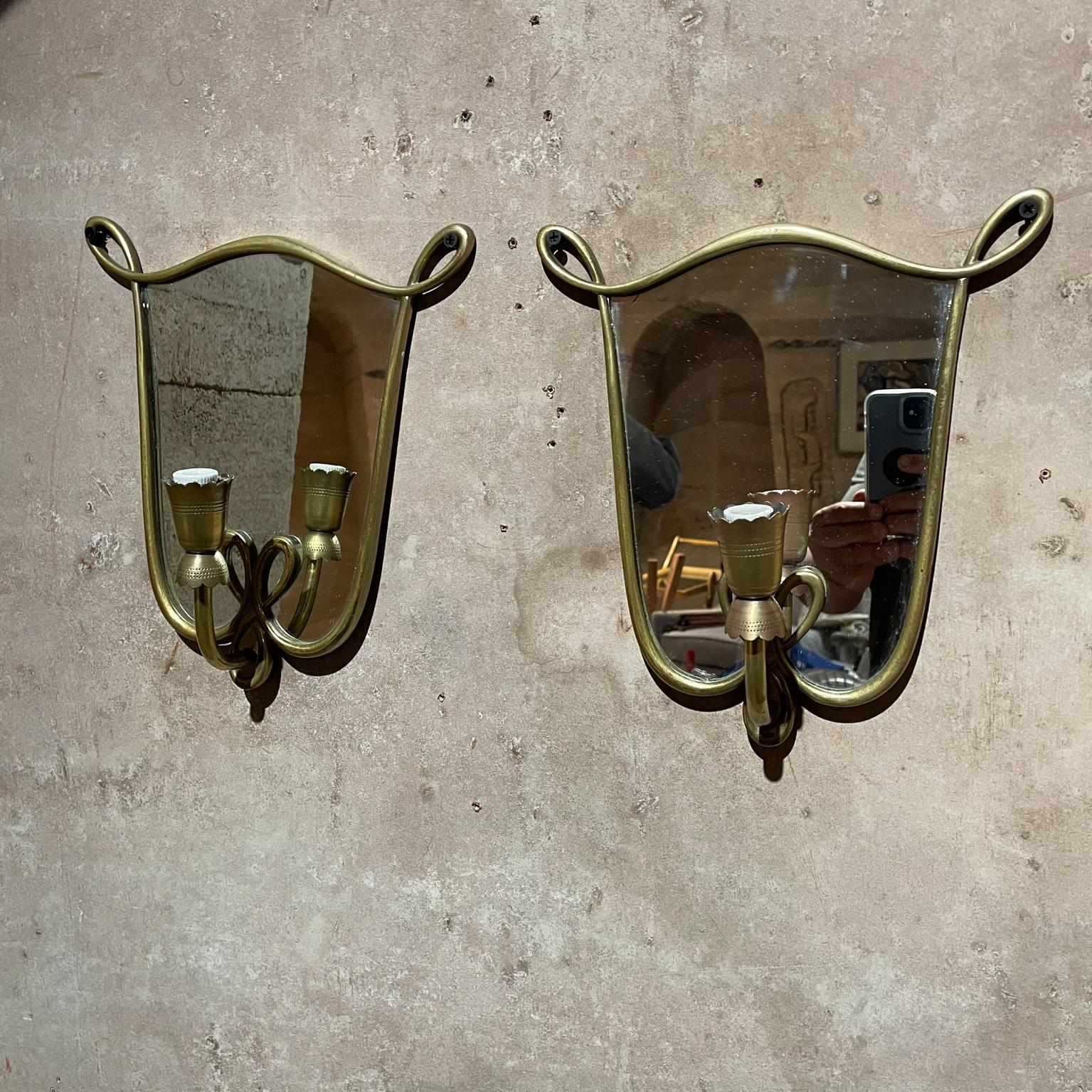 Wall sconces
So beautiful!! Pretty Italian wall sconces in the style of GIo Ponti. 
Swirled ribbon frame in bronze with antique vintage mirror, Italy 1950s.
Lovely scalloped edge perforated design.
Unmarked.
Measures: 11 tall x 10 D x 4