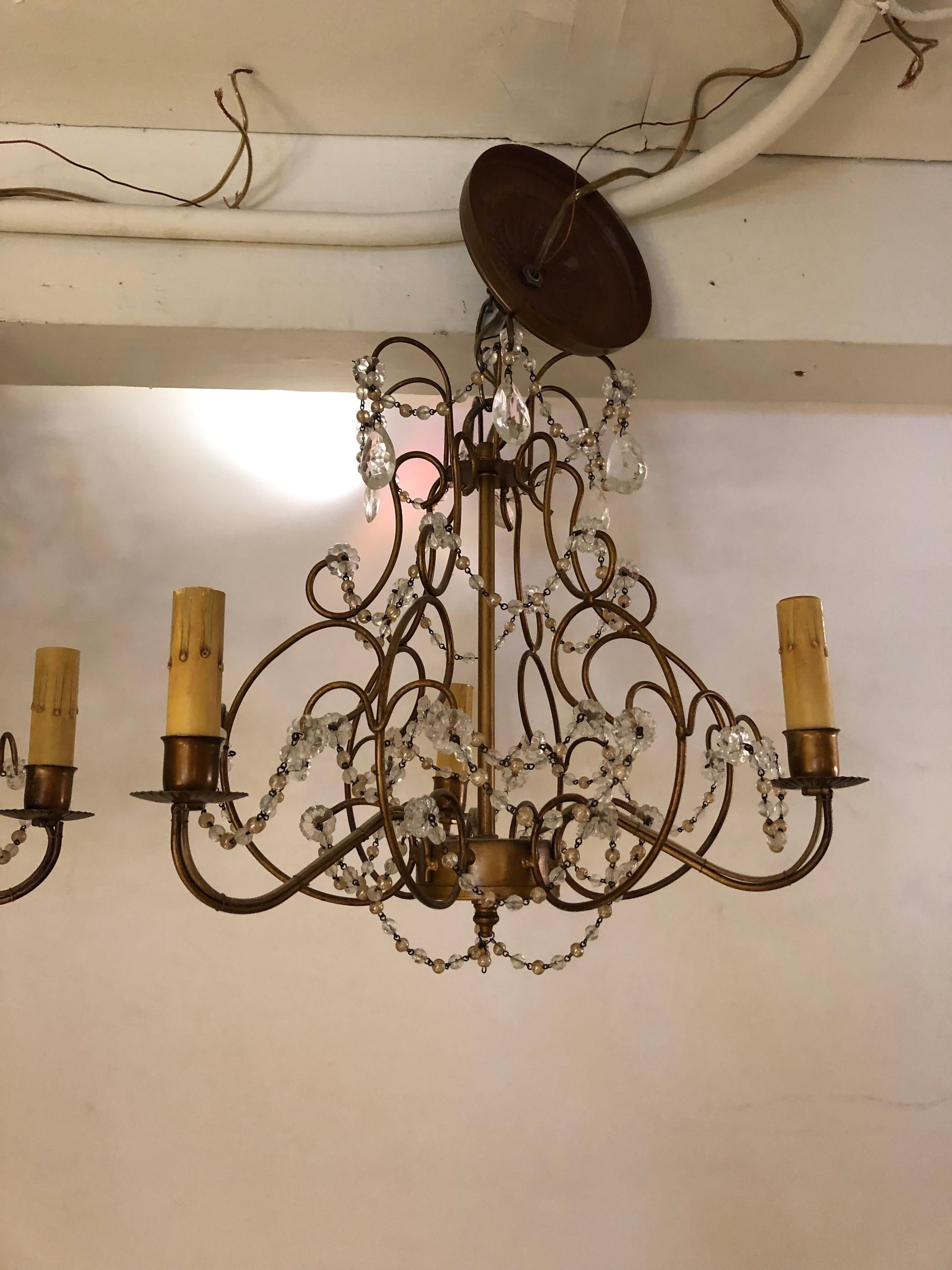 Lovely pair of gilded Italian Venetian small chandeliers having 3 arms and pretty crystal beading. Ceiling canopies included.