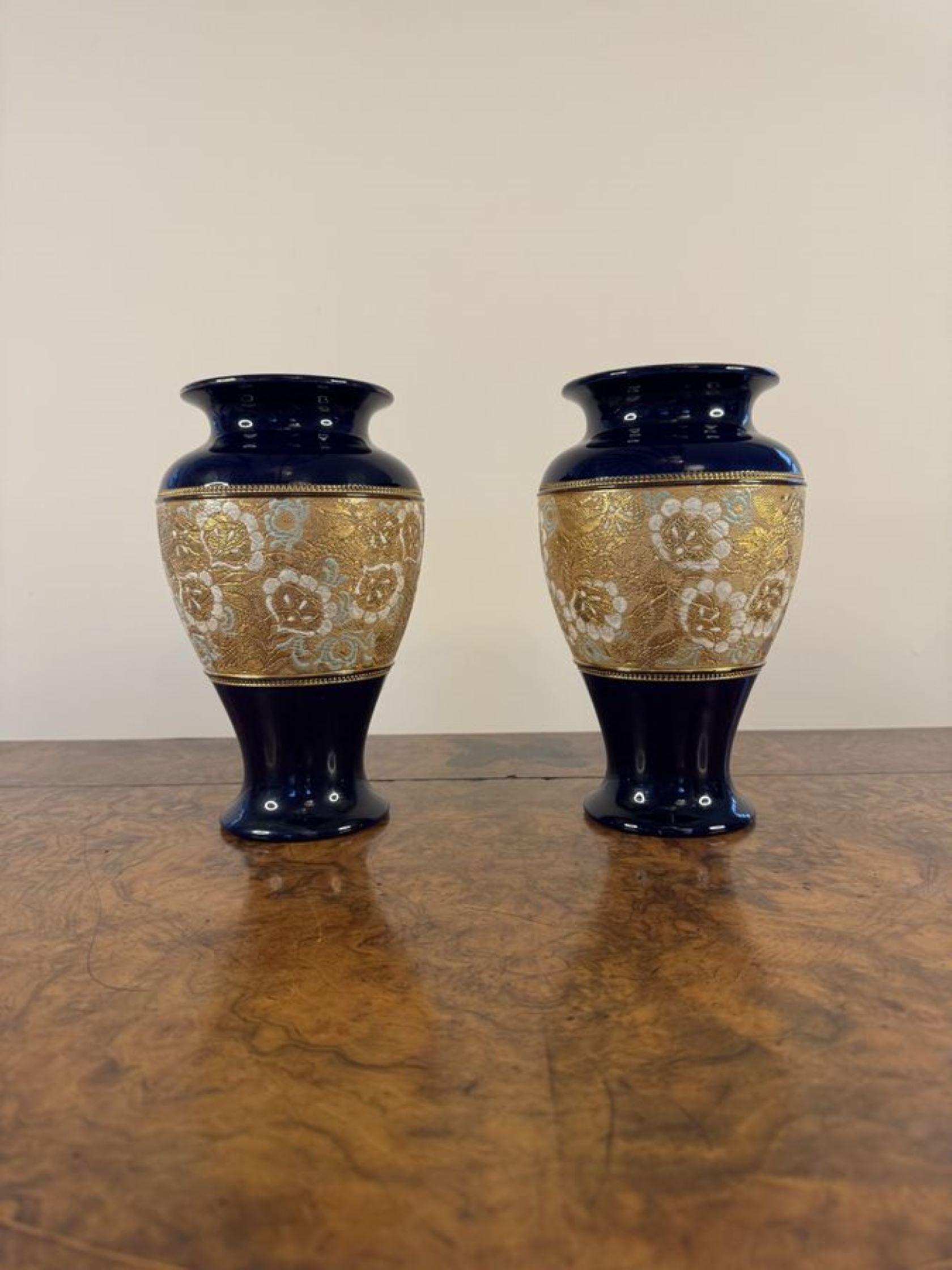 Pretty pair of quality antique Royal Doulton vases having a quality pair of Royal Doulton slaters shaped vases with royal blue fluted shaped necks and a bulbous shaped body decorated with embossed flowers and leaves in white and blue colours on a