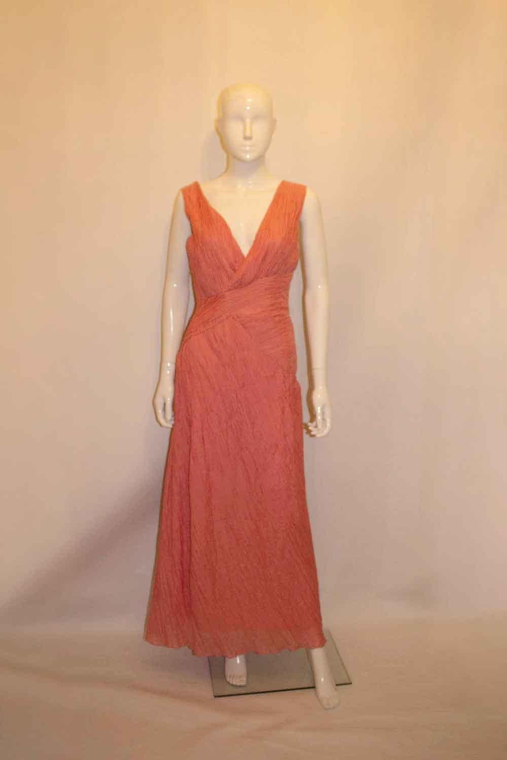 A wonderful and easy to wear and pack, pink Grecian style gown in a silk and cotton mix. 
With wonderful pleat detail, the dress has a v neckline  and is fully lined .
US size 10 , measurements : Bust up to 36'', length 60''
