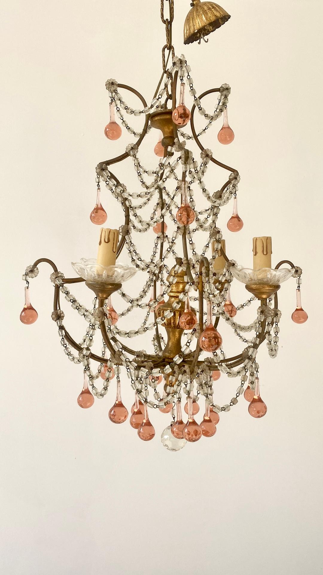 A very pretty gilded birdcage chandelier with 4 lamps.

Finished with pink droplets and swathed all over with the original glass necklaces.

Measures 58cm from top of light to bottom crystal, comes with original chain and ceiling rose (38cm in