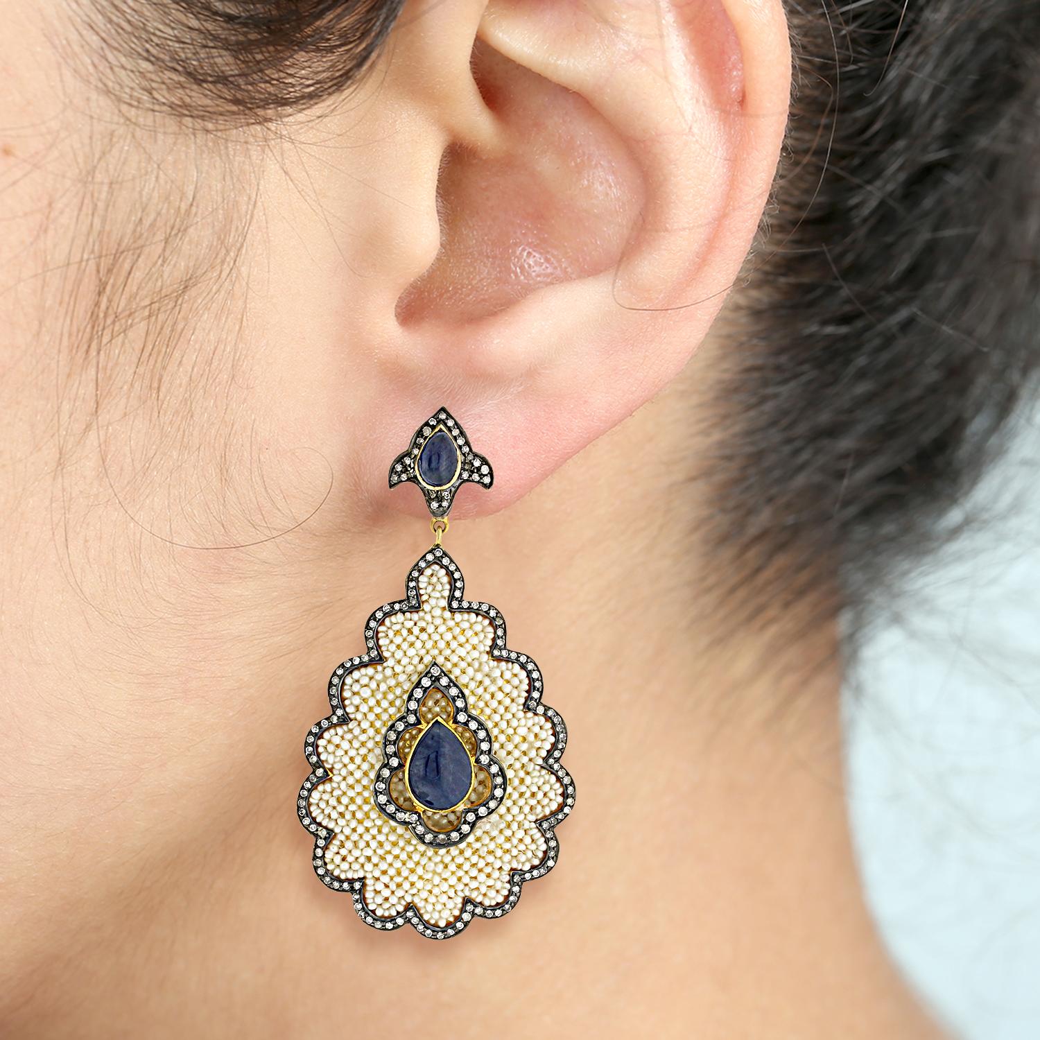 This pretty seed pearl earring with diamonds and blue sapphire in gold and silver is unique and all handmade by finest artisans. 

Closure: Push Post

18k: 4.35g
Diamond: 2.54ct
Sapphire: 9.52cts
Pearl: 15.10cts
