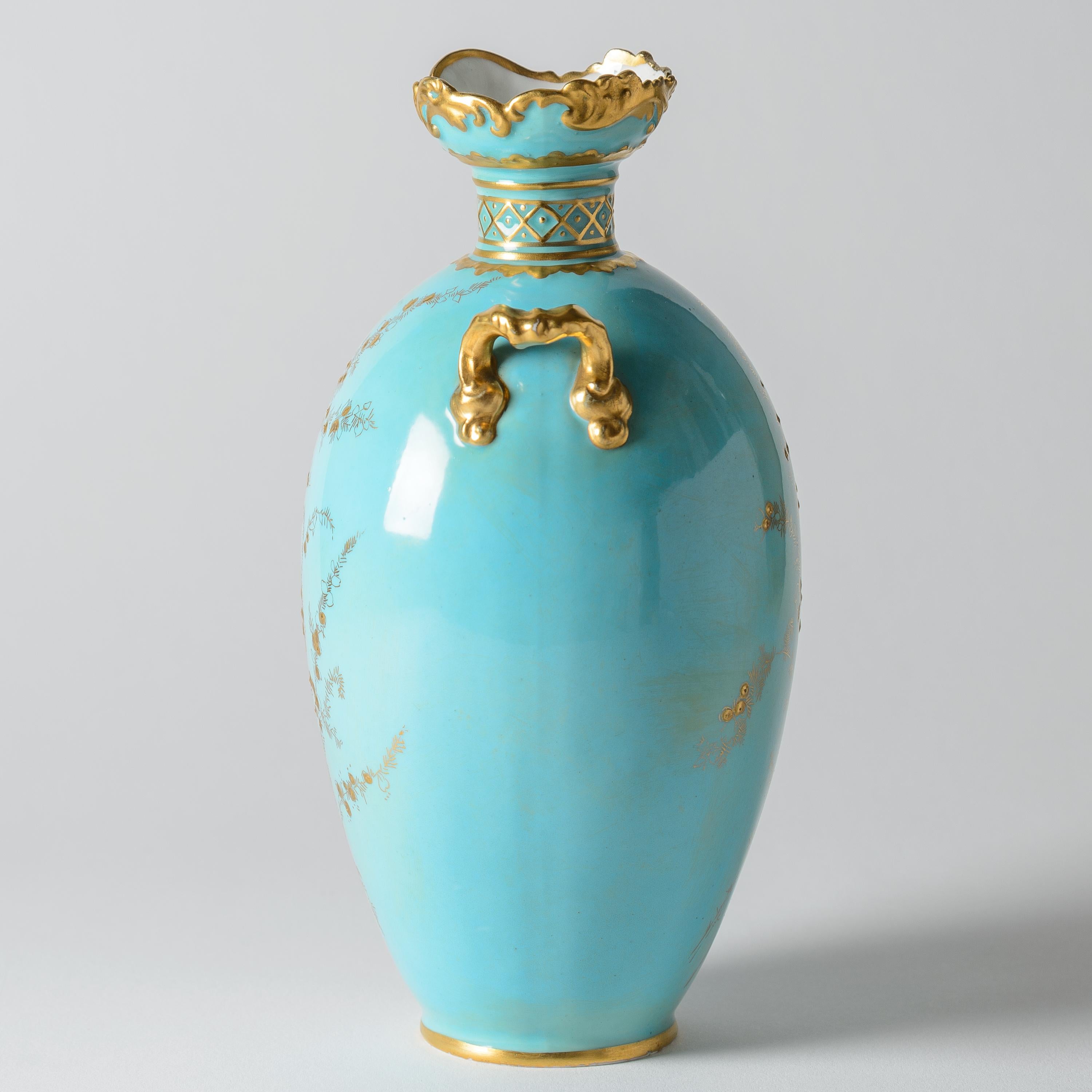 A vibrant turquoise and raised paste gilded vase by one of England's finest porcelain factories: Royal Crown Derby. Lovely details to the handles and slight ruffle edge top. Retailed by one of Boston's prestigious Gilded Age shops Shreve Crump and