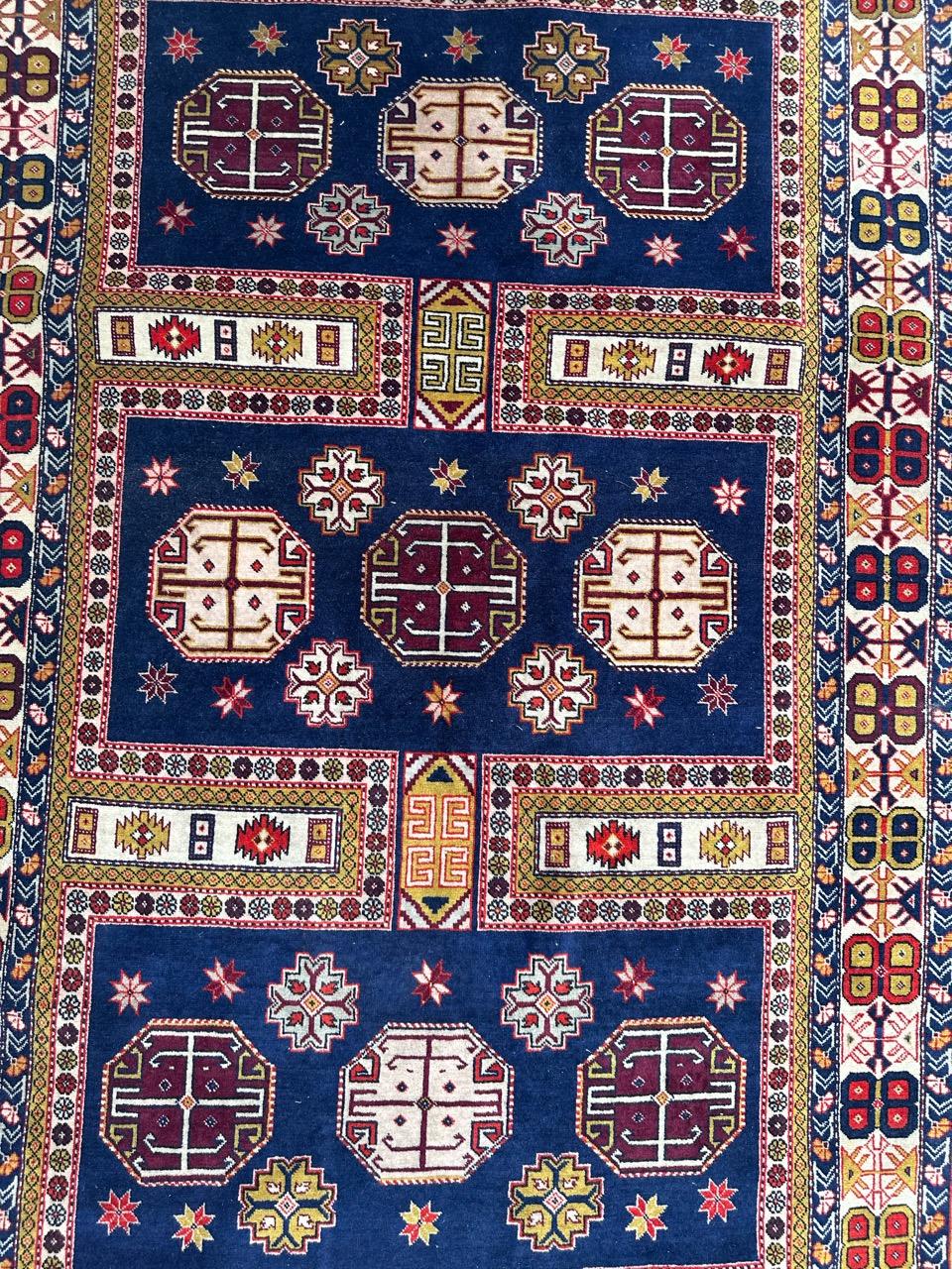 A meticulously handwoven 1970s-1980s Azerbaijani Chirwan rug, entirely crafted by skilled artisans using pure wool on a cotton foundation. This stunning piece features stylized designs reminiscent of ancient Caucasian Chirwan rugs, with three