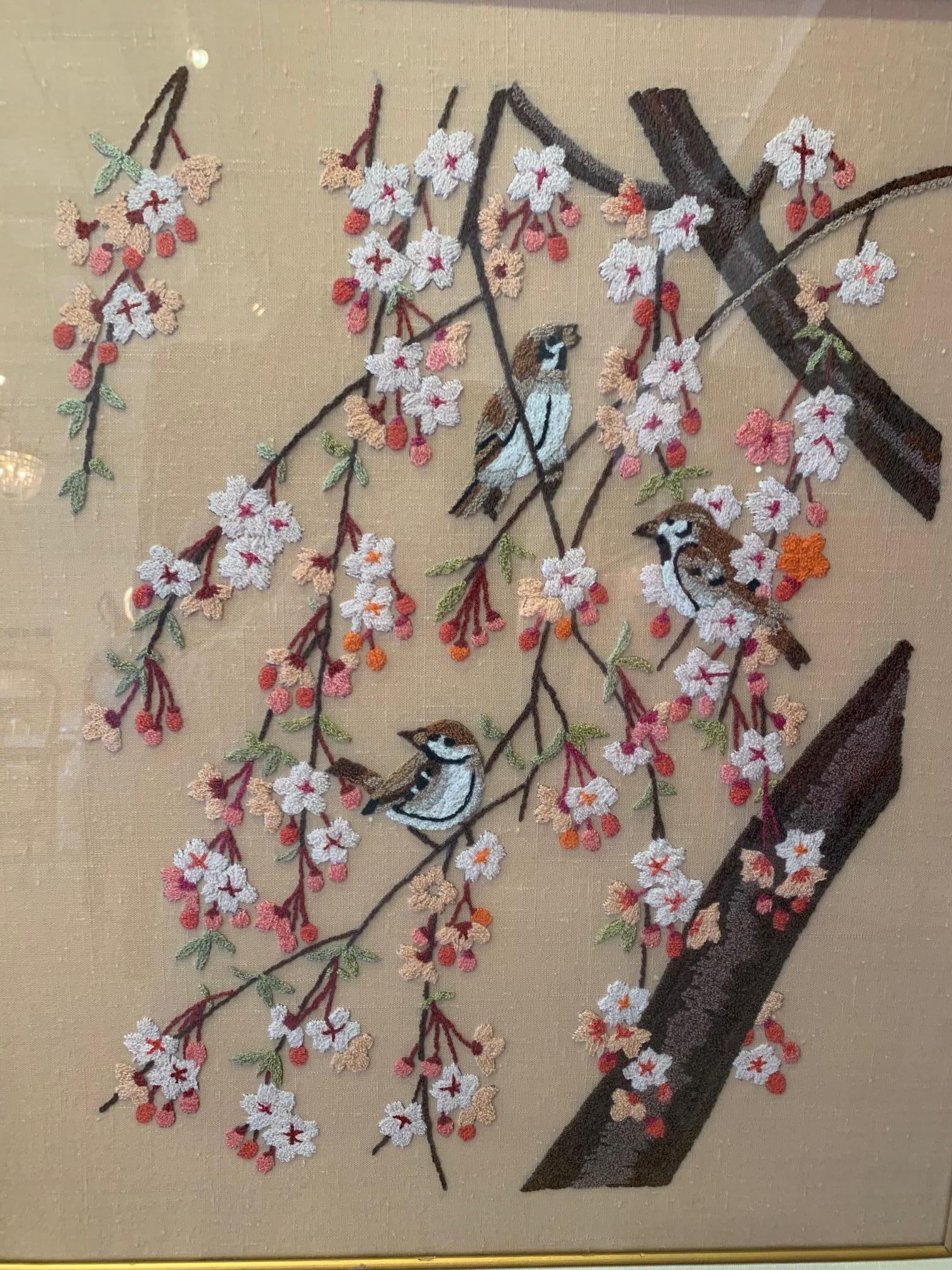Pretty crewel work piece of art depicting lovely composition of two birds and cherry blossoms elegantly matted and framed.