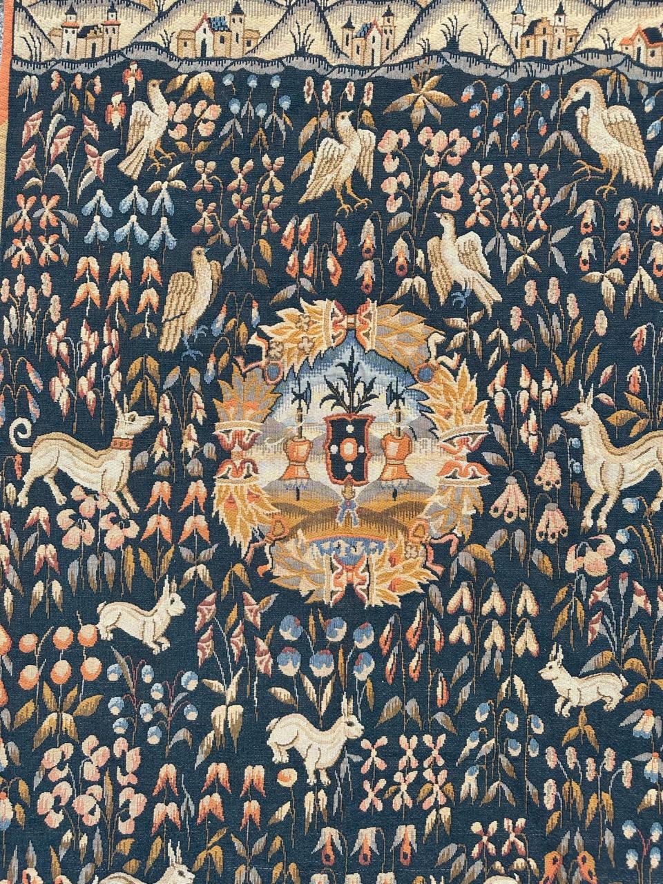 Introducing a stunning midcentury French Flanders tapestry from the renowned Halluin  manufacturing This exquisite piece features a captivating design inspired by 16th-century museum tapestries, showcasing vibrant colors. Woven with precision by the