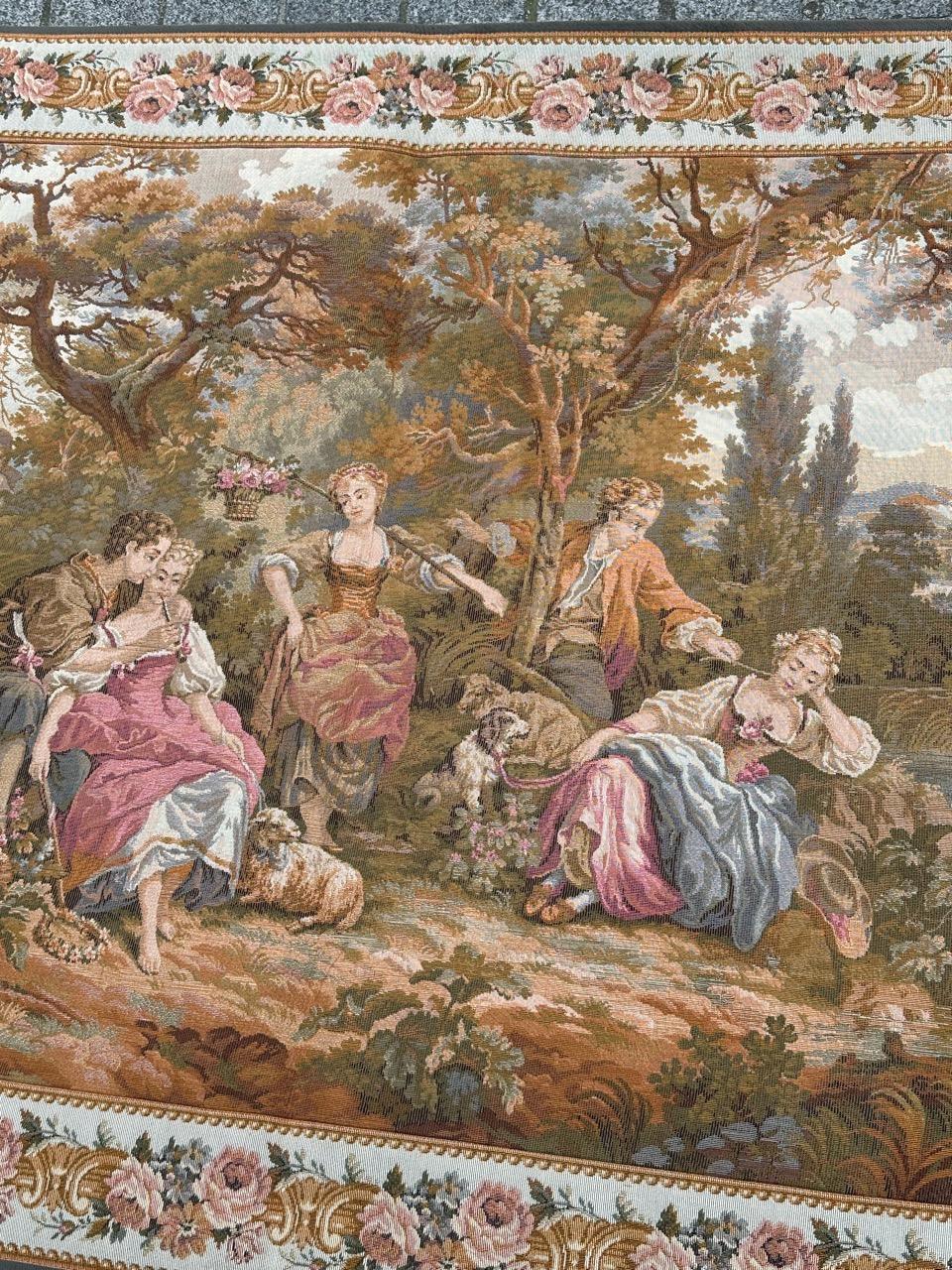 Introducing a magnificent 20th-century tapestry that captures the essence of the gentle joys of life, festivities, music, and above all, love. Set against a rustic backdrop, shepherds and shepherdesses embrace amid a serene landscape with a few