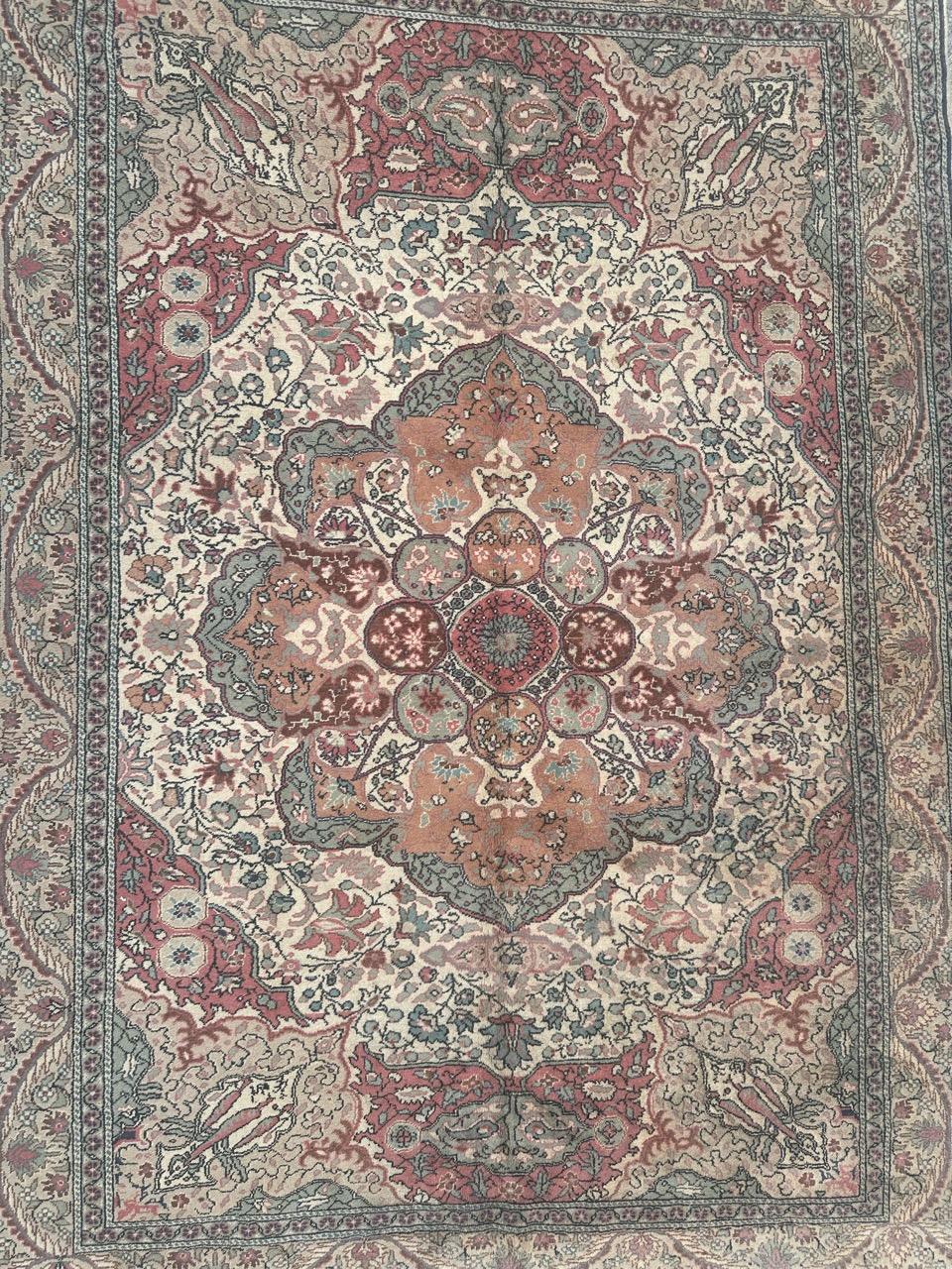 Beautiful Turkish Kayseri rug dating back to the mid-20th century. Expertly hand-knotted in wool on a cotton foundation, featuring an exquisite stylized floral design with a central medallion and with the color palette of orange, purple, green,