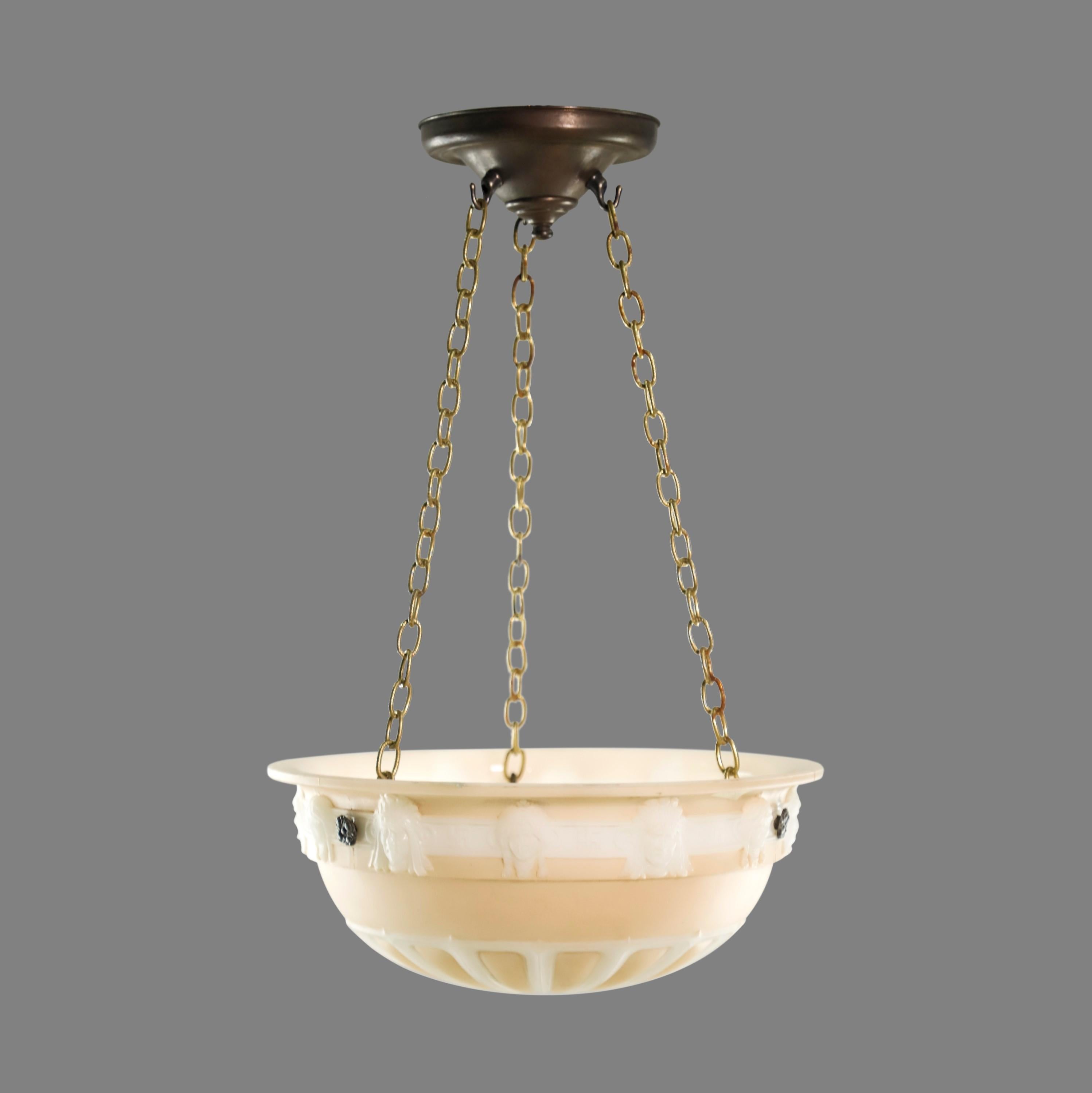 Cast glass beige and white dish pendant light with figural female heads suspended from three chains with a brass fitter. Cleaned and restored. This is in good condition from the Pre-War era. Takes three standard medium base lightbulbs. Please note,